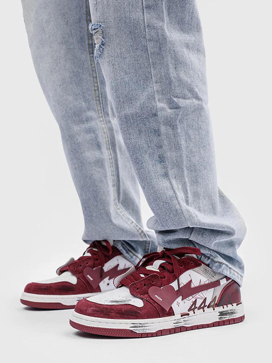 Casual vibe with TALISHKO graffiti skate shoes in red and white, styled with light denim jeans.
