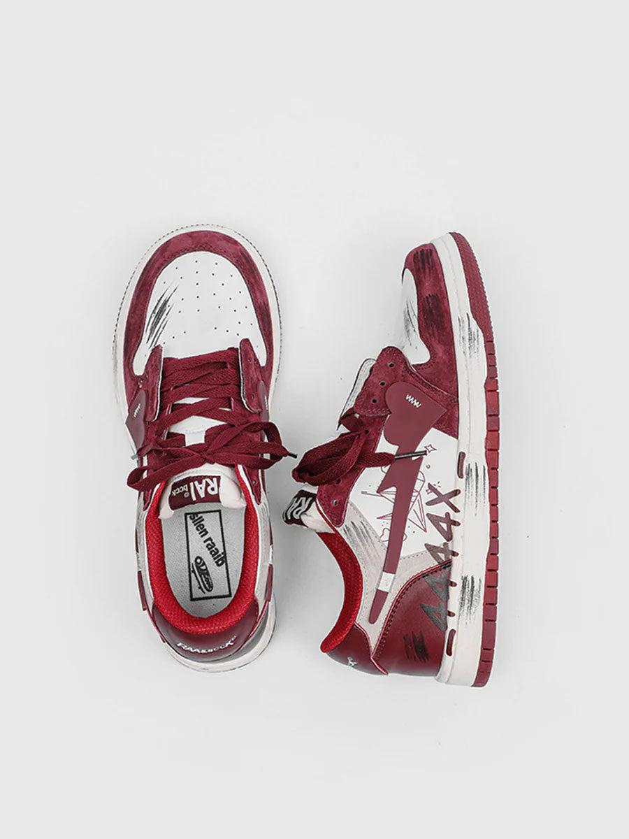 Top view of TALISHKO graffiti skate shoes in red and white, highlighting their artistic design.