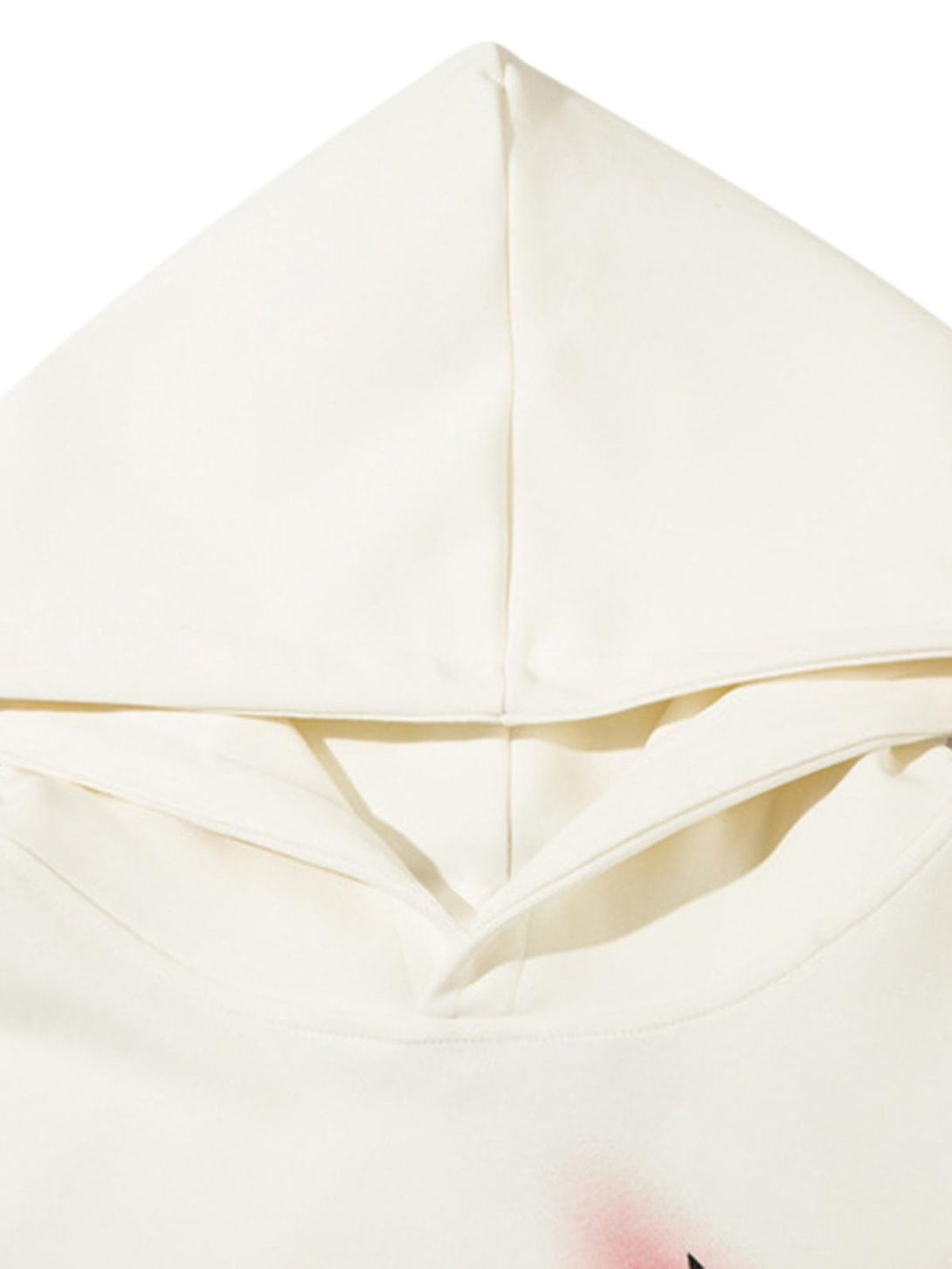 A detailed view of the hood on a white graffiti star hoodie by TALISHKO.