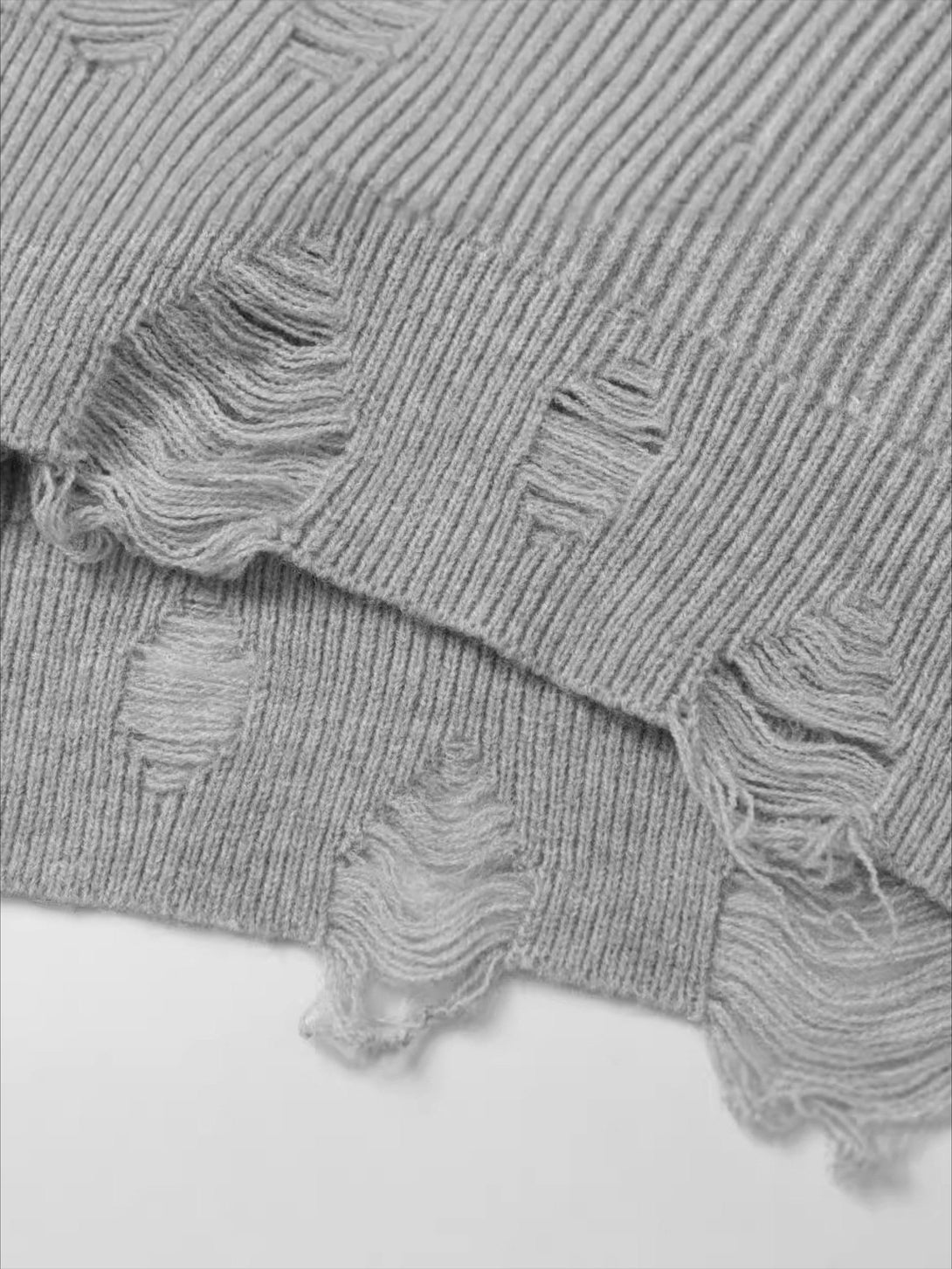 TALISHKO cardigan's fabric with distressed details and ribbed texture for a unique street vibe.
