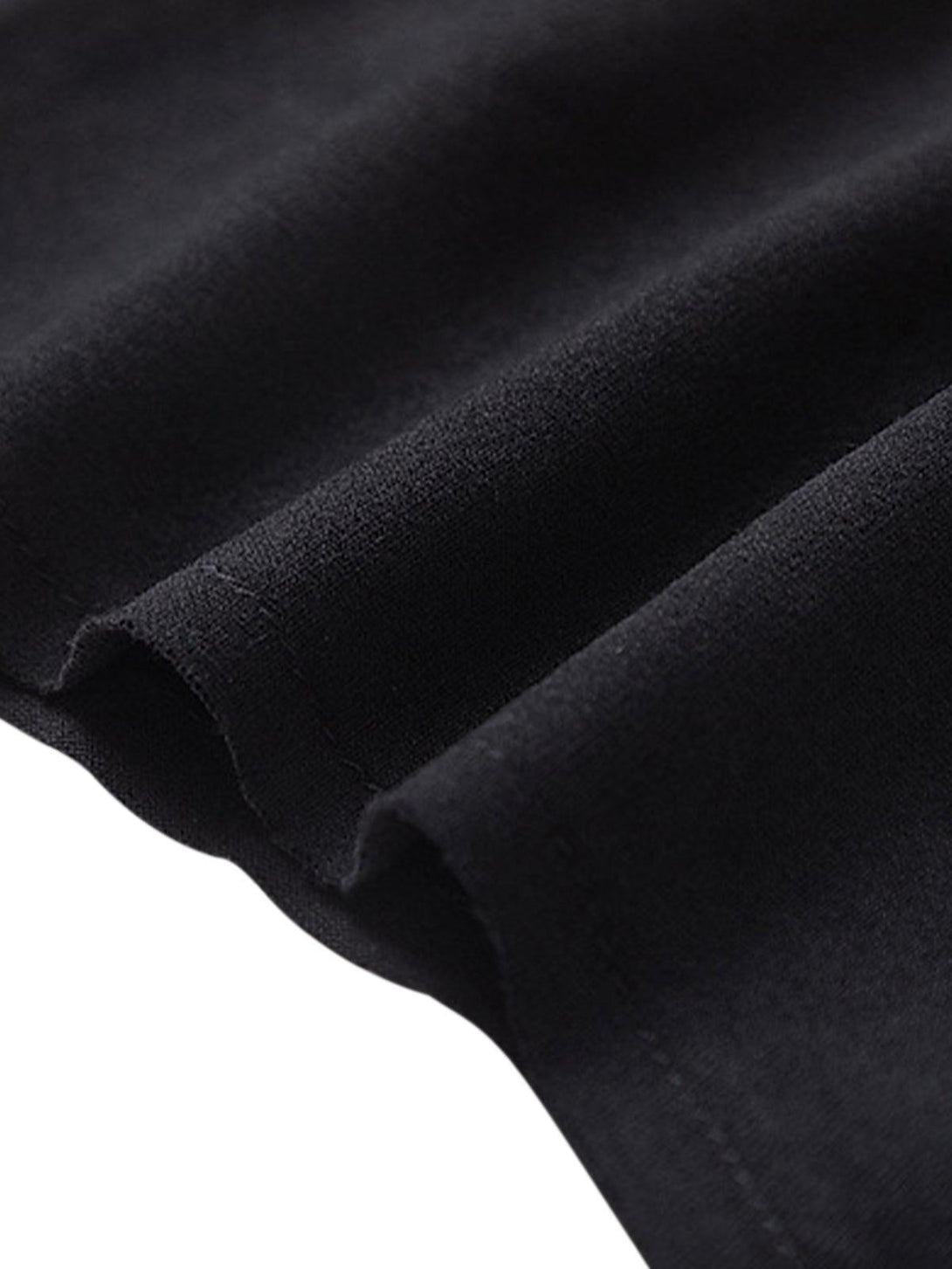 Detailed fabric and stitching of a black vest by TALISHKO, highlighting quality craftsmanship.