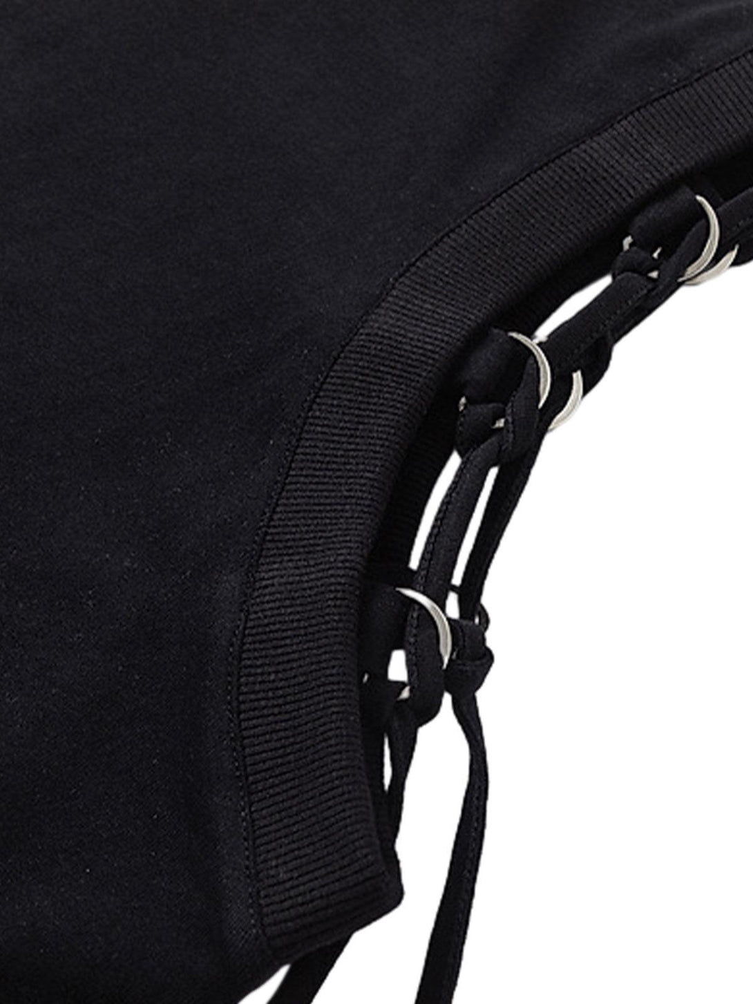 Intricate look at adjustable strap details on a black vest by TALISHKO, enhancing edgy style.