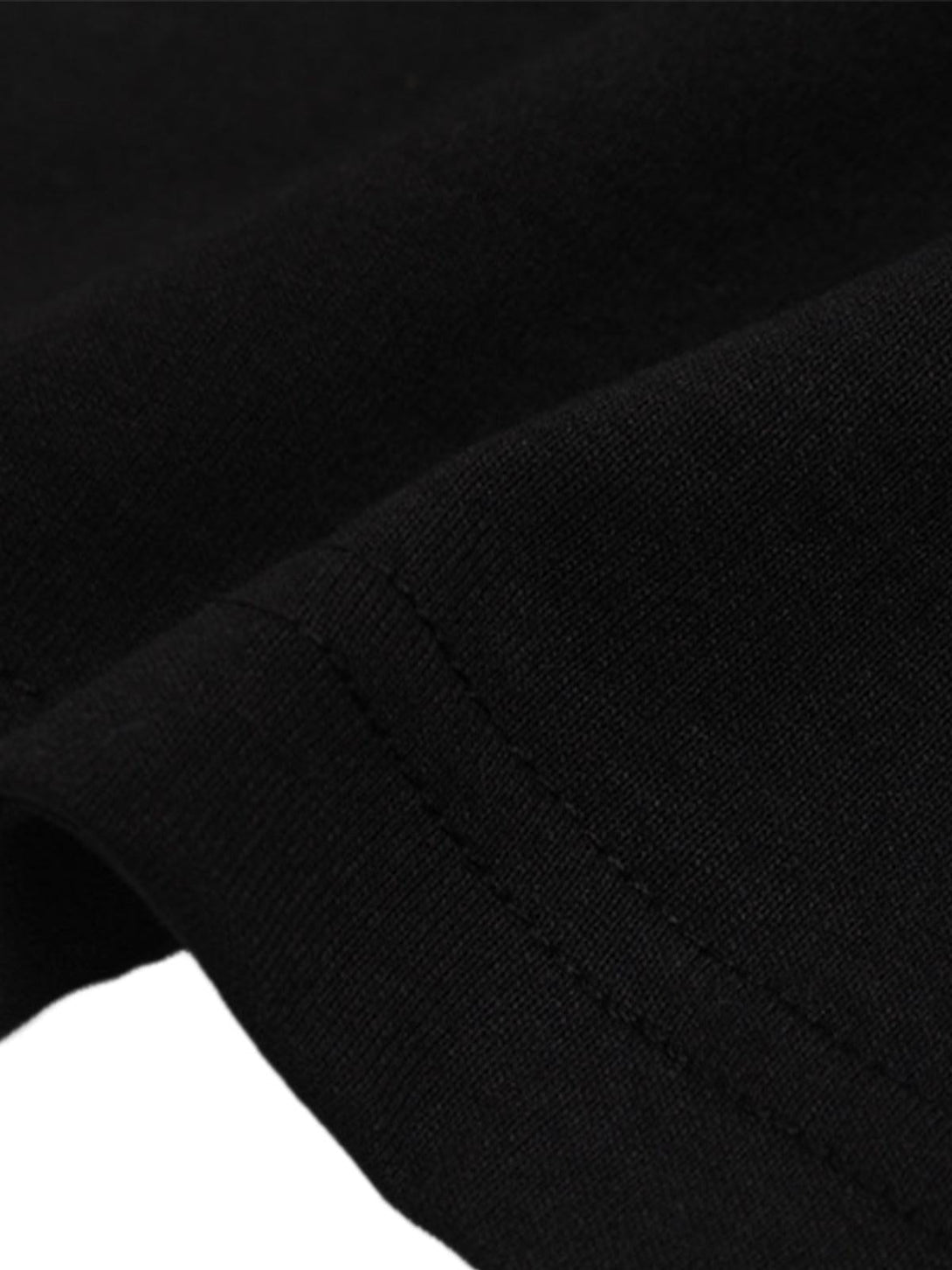 Detailed fabric and stitching of TALISHKO's graphic "BREAK" print T-shirt sleeve.