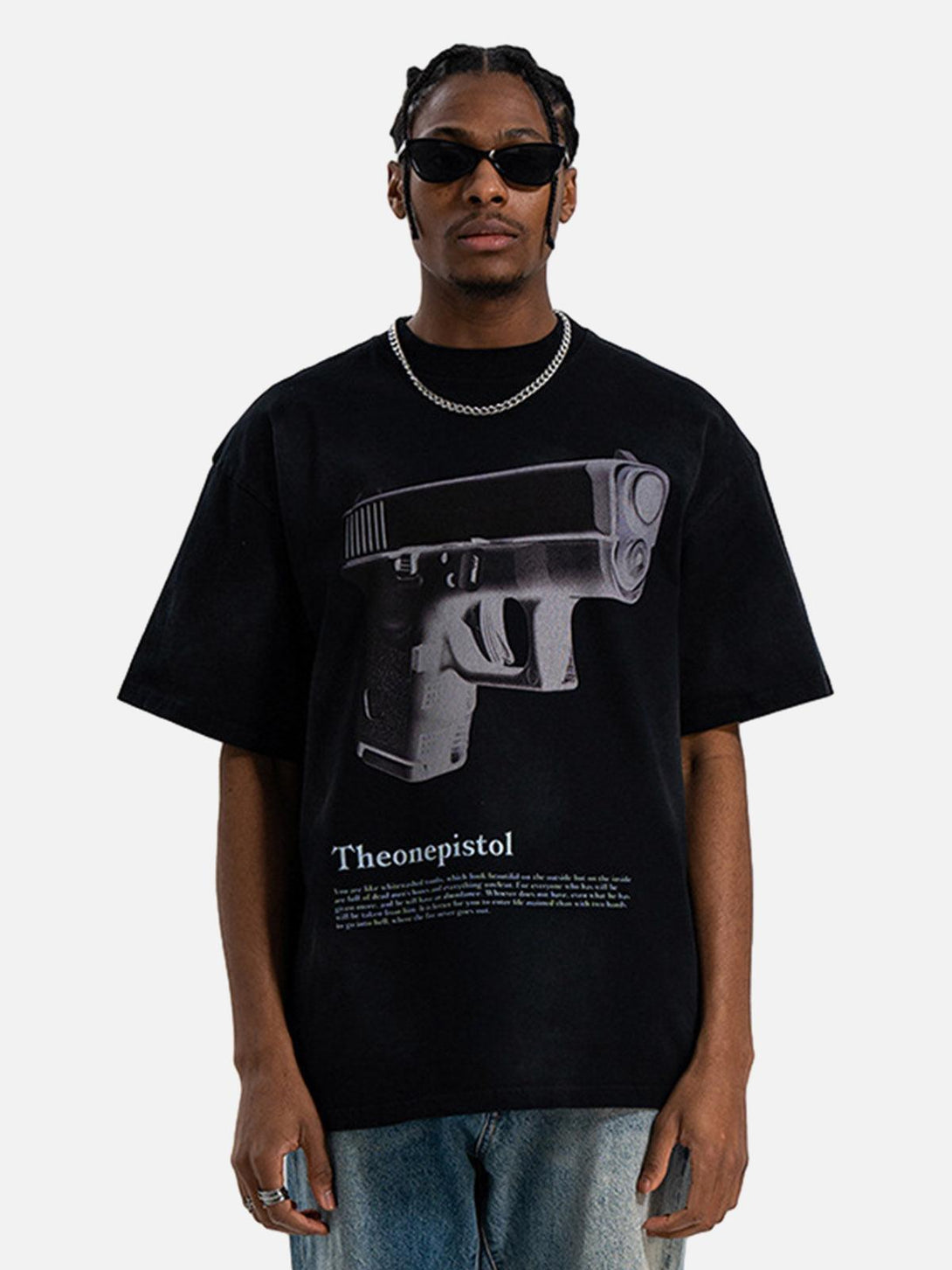Model in a graphic gun print T-shirt by TALISHKO, exuding bold urban style with edgy flair.