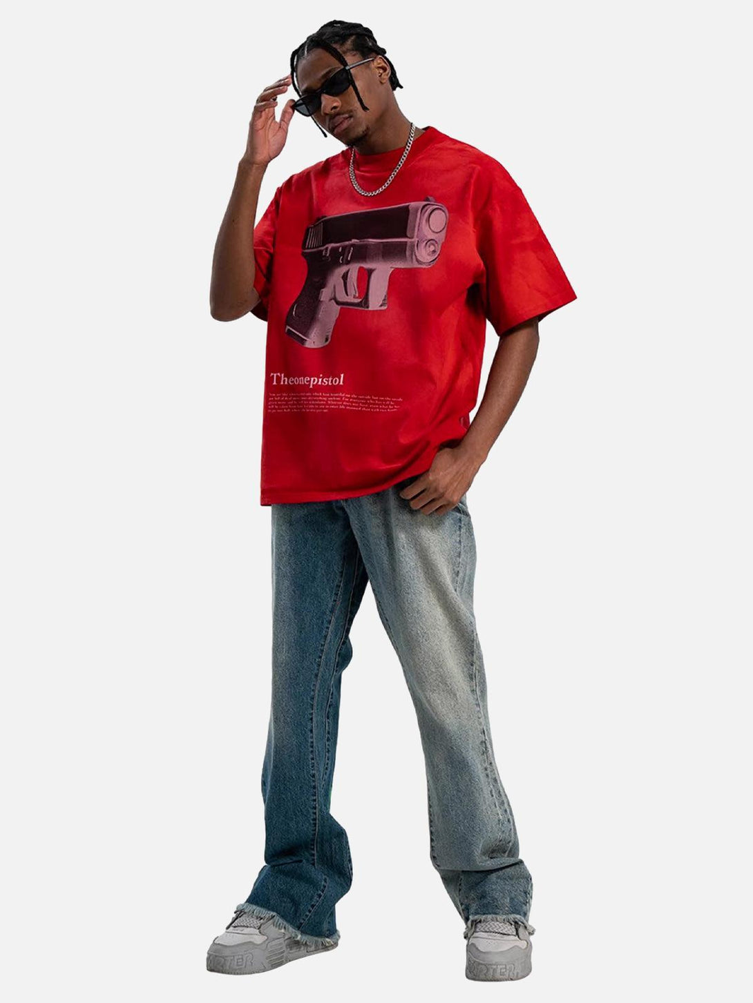 Model styled in a red graphic T-shirt by TALISHKO, embodying bold urban summer vibes.