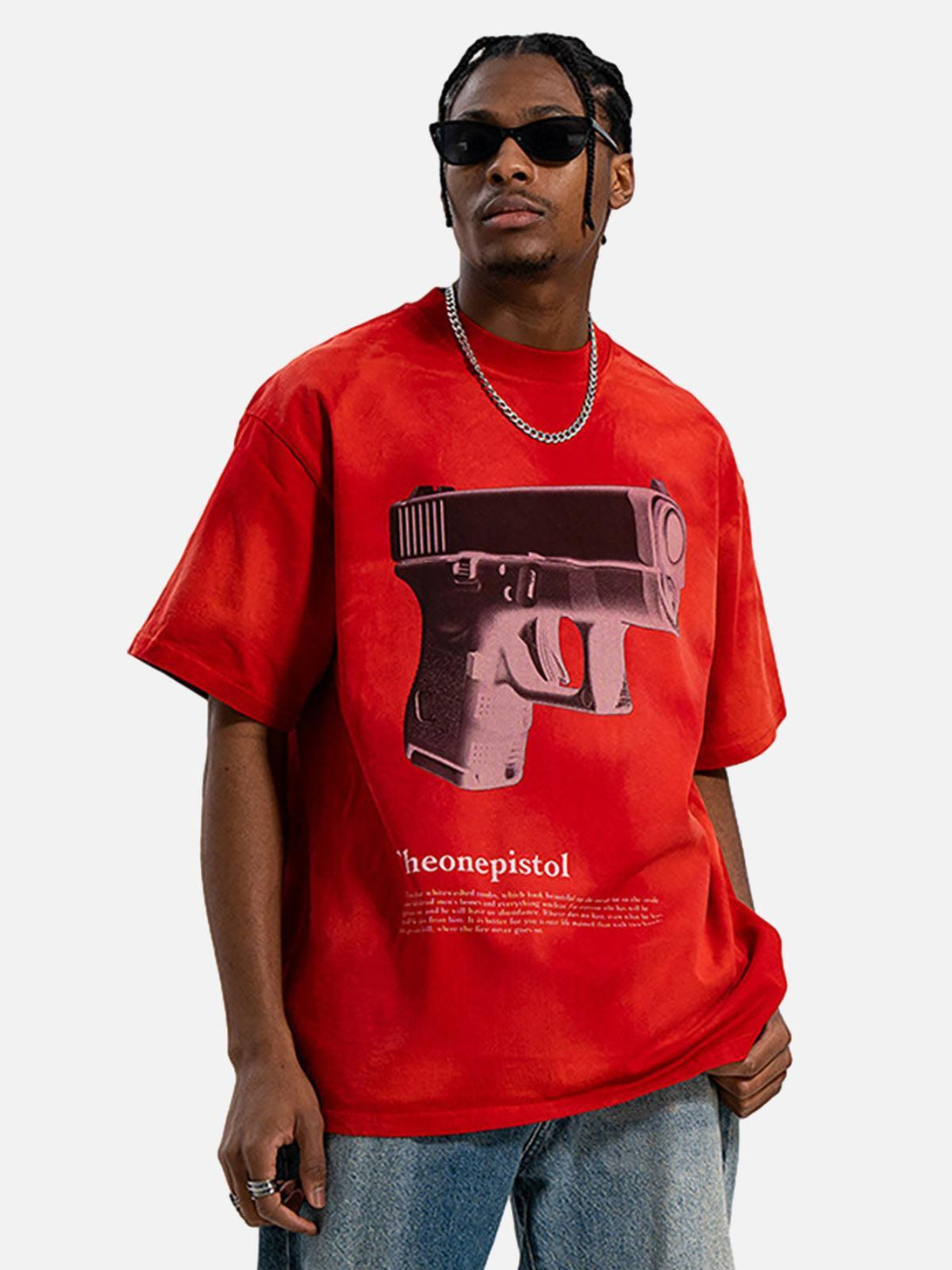 Model wearing a red graphic gun print T-shirt by TALISHKO, capturing bold urban flair.