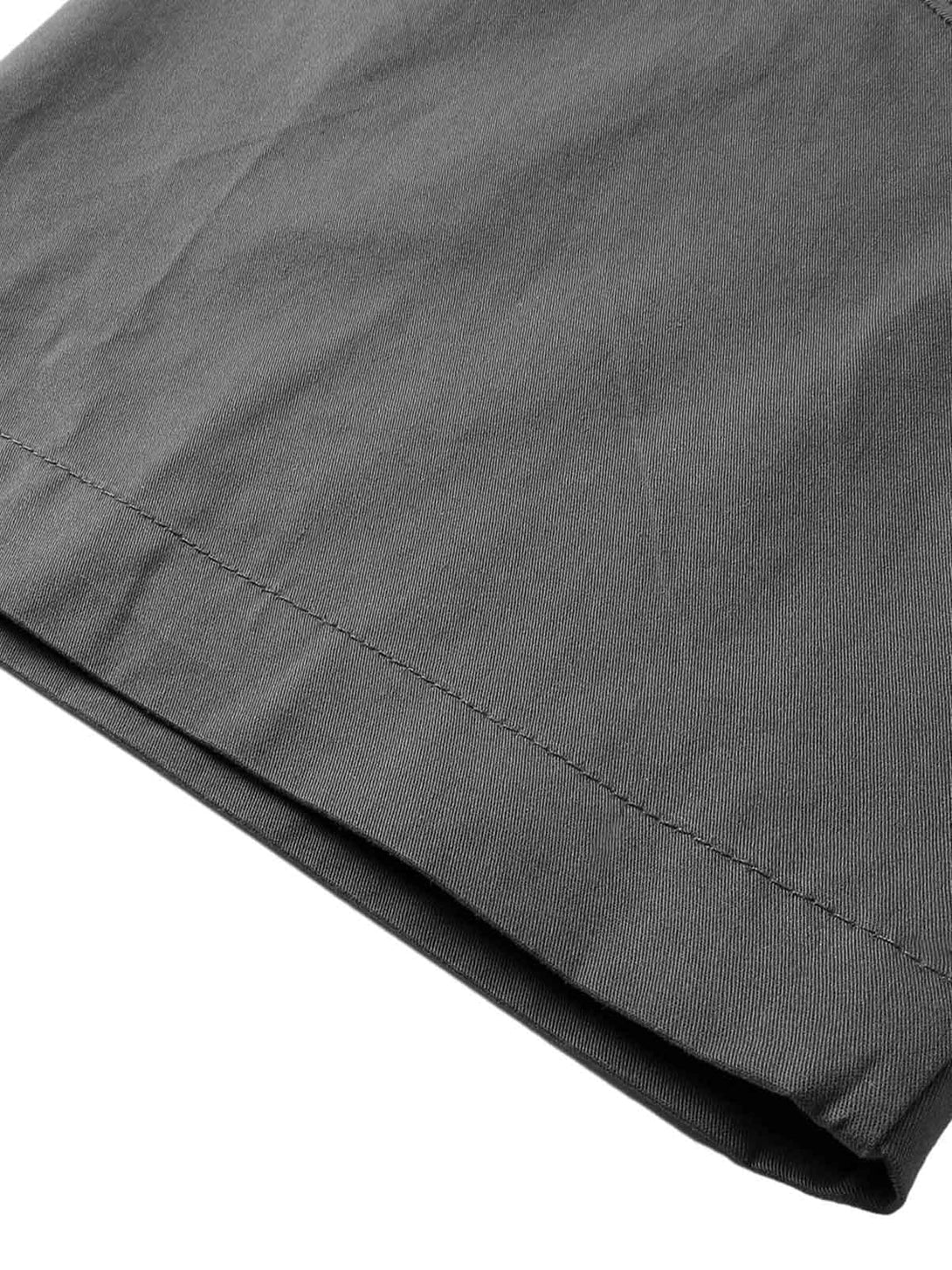 Focusing on the dark gray fabric and stitching detail of a TALISHKO shirt sleeve.