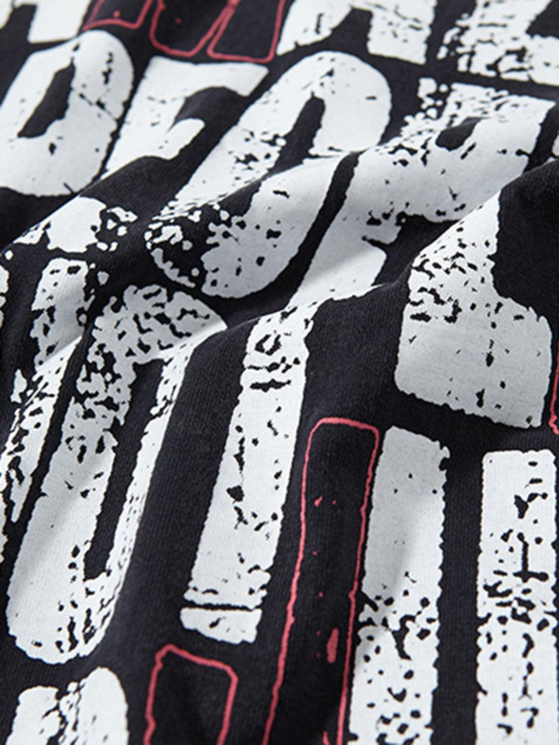 Zoomed-in texture of TALISHKO graphic lettering chain vest, showcasing bold text design.