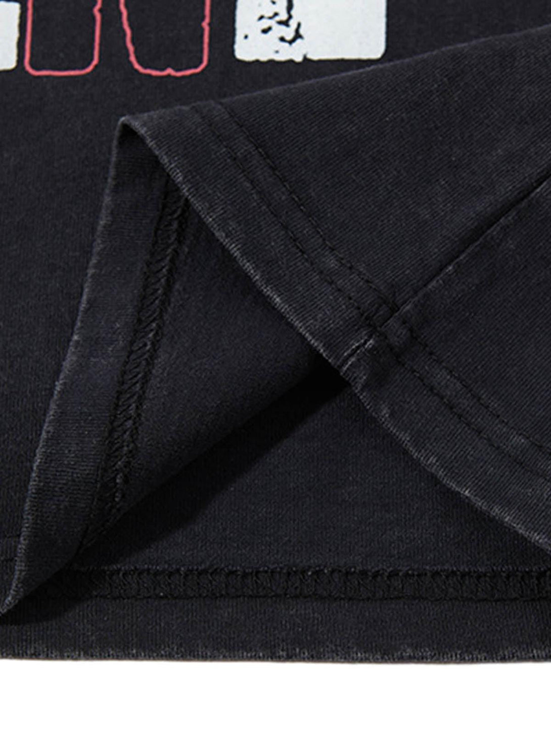 Intricate look at TALISHKO graphic lettering vest, highlighting detailed stitching and texture.