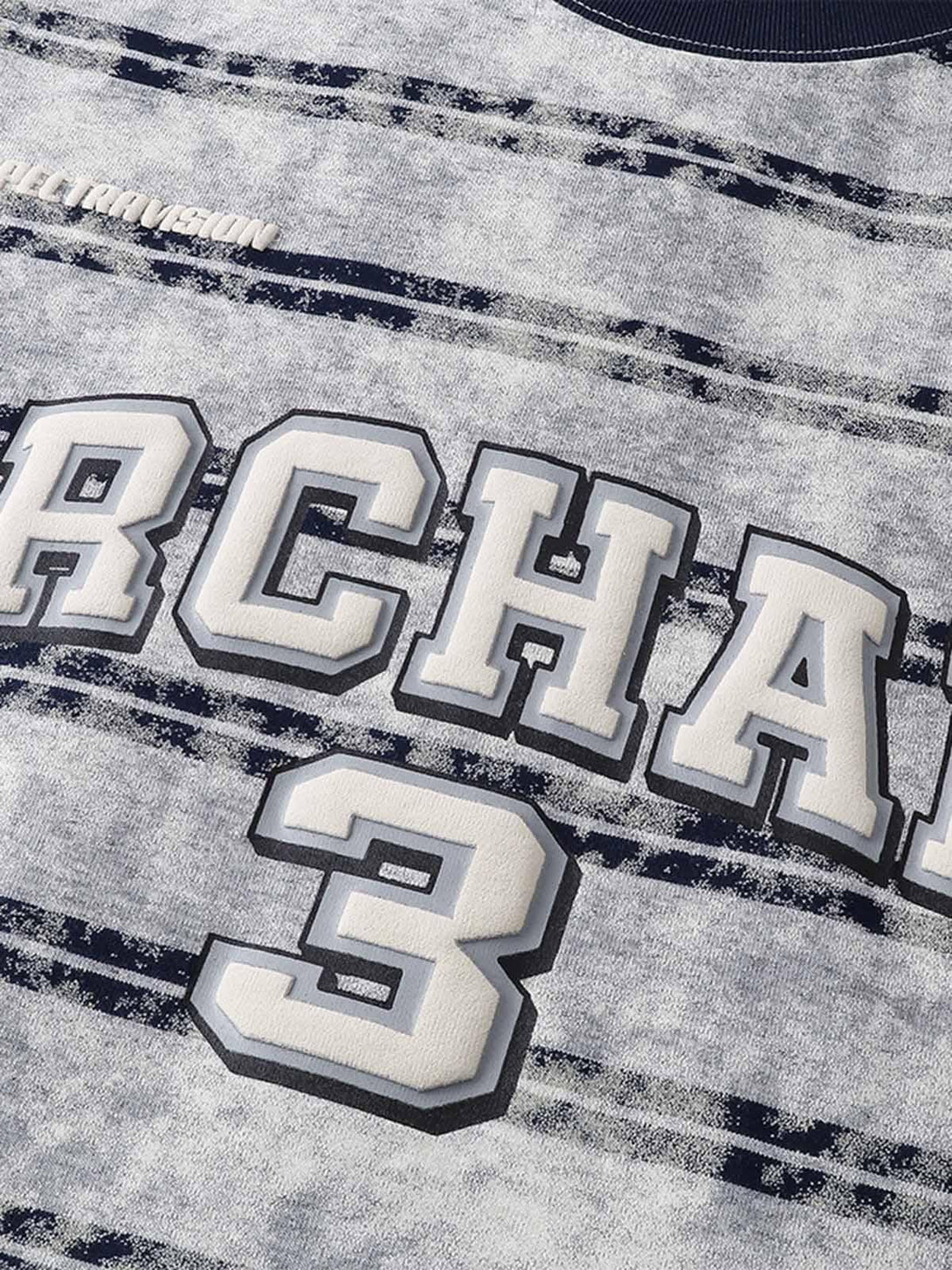 Close-up of graphic lettering and number on striped oversized T-shirt by TALISHKO.