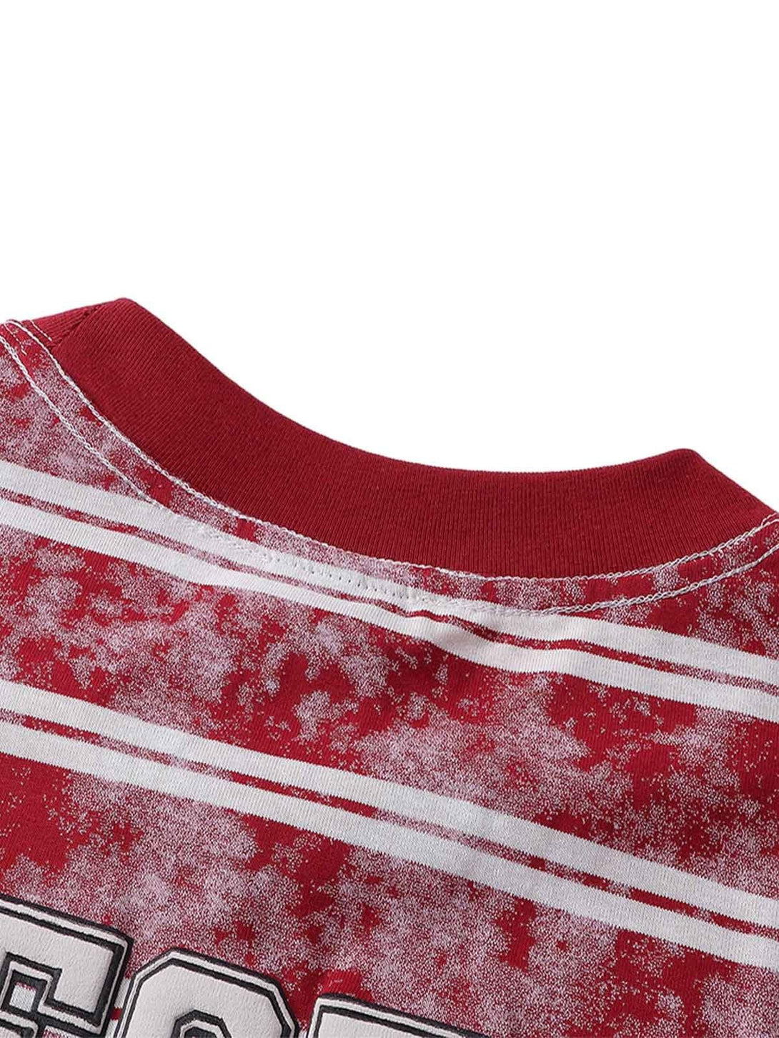Detailed view of TALISHKO's red striped oversized T-shirt showcasing unique fabric texture.