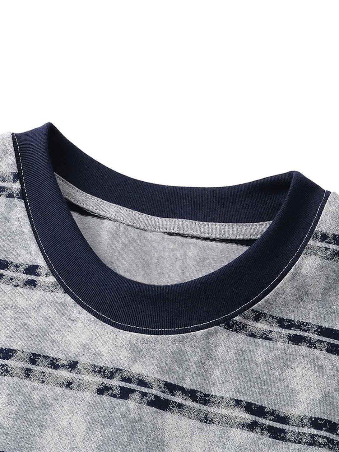 Detailed fabric and stitching of TALISHKO's striped oversized T-shirt with graphic accents.