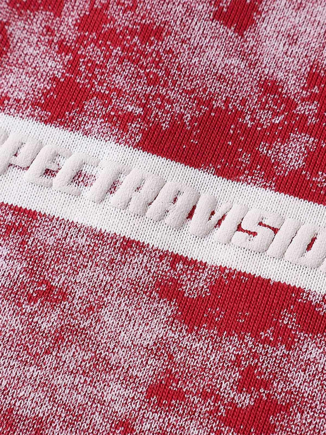 Zoomed-in texture of TALISHKO's red striped oversized T-shirt featuring graphic lettering.