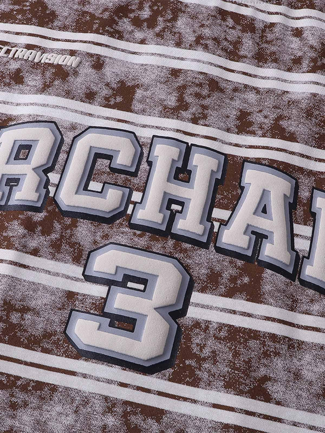 A detailed view of graphic lettering and number on a striped T-shirt by TALISHKO.