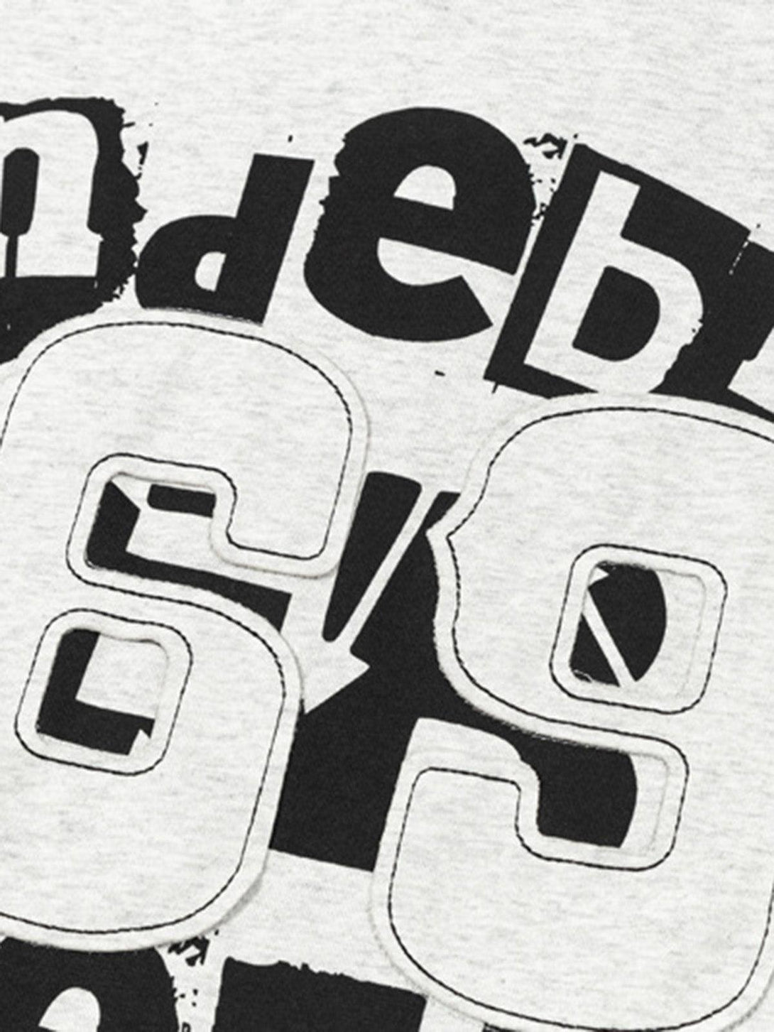 A close-up of a TALISHKO graphic T-shirt with bold black and white letter and number details.