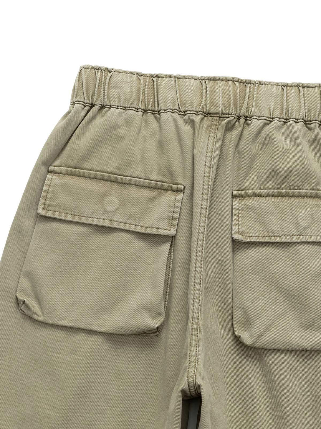 Back view of khaki drawstring shorts by TALISHKO, showcasing dual flap pockets.