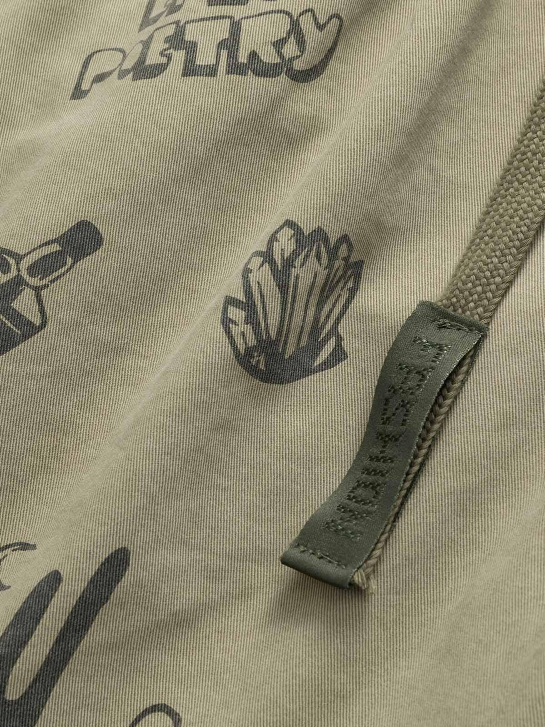 A detailed view of TALISHKO shorts featuring playful graphic prints and sturdy drawstring detail.