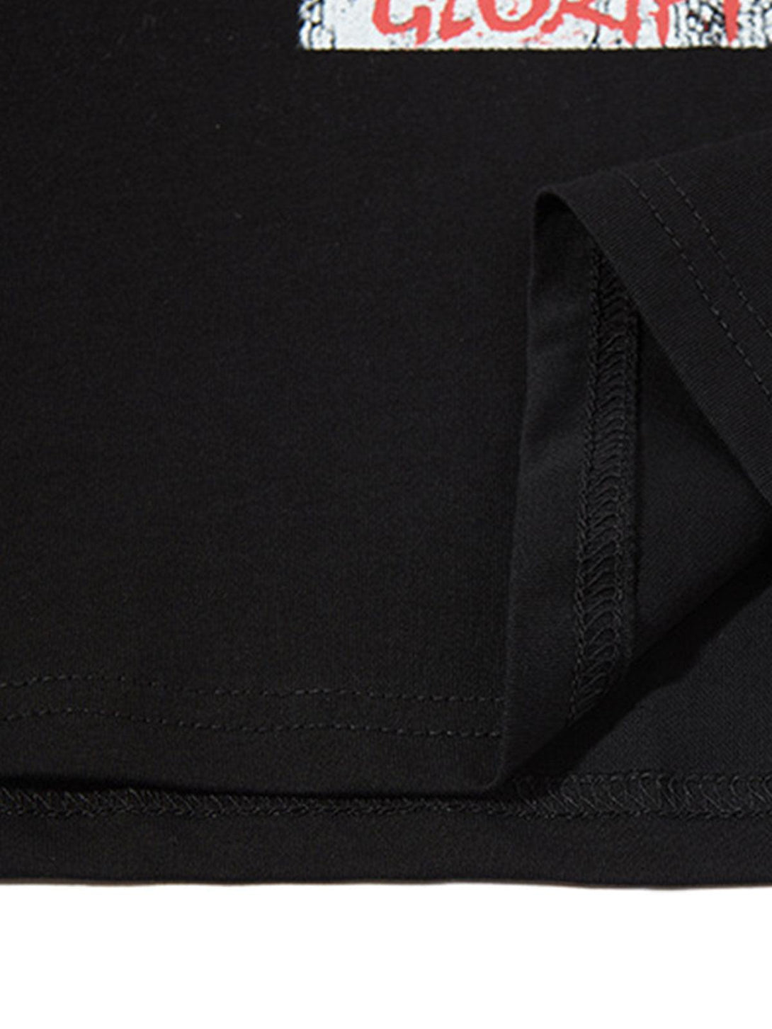 Intricate look at TALISHKO's black graphic vest hem, highlighting stitching and fabric detail.