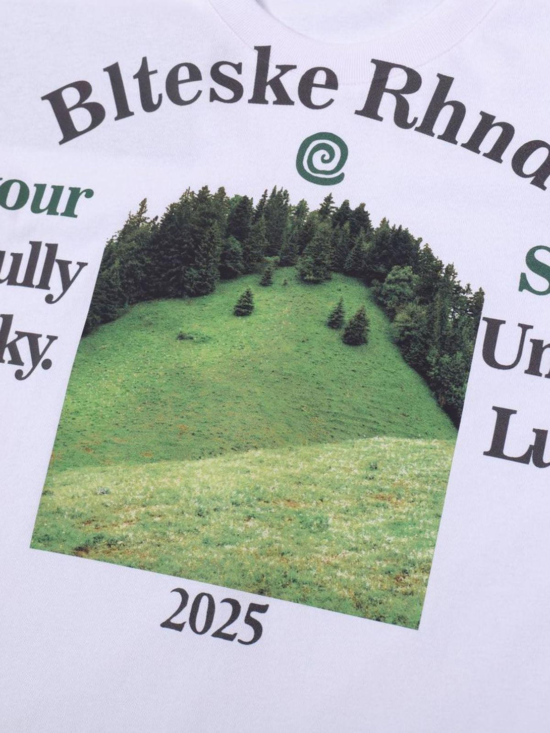 Close-up of a scenic graphic on a TALISHKO T-shirt, featuring lush greenery for a relaxed vibe.