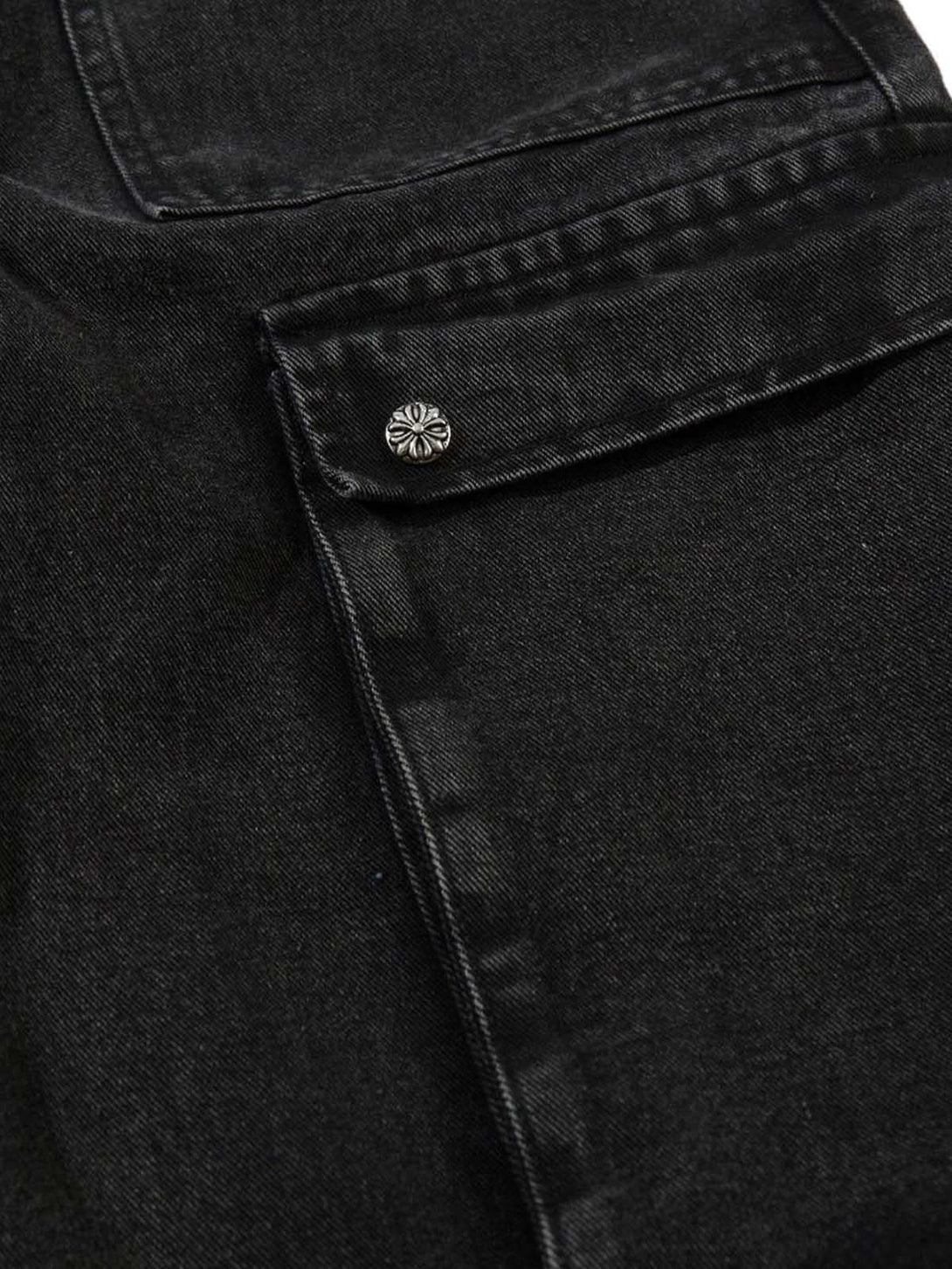 Detailed fabric and stitching of TALISHKO cargo jeans, highlighting pocket design and grommet detail.