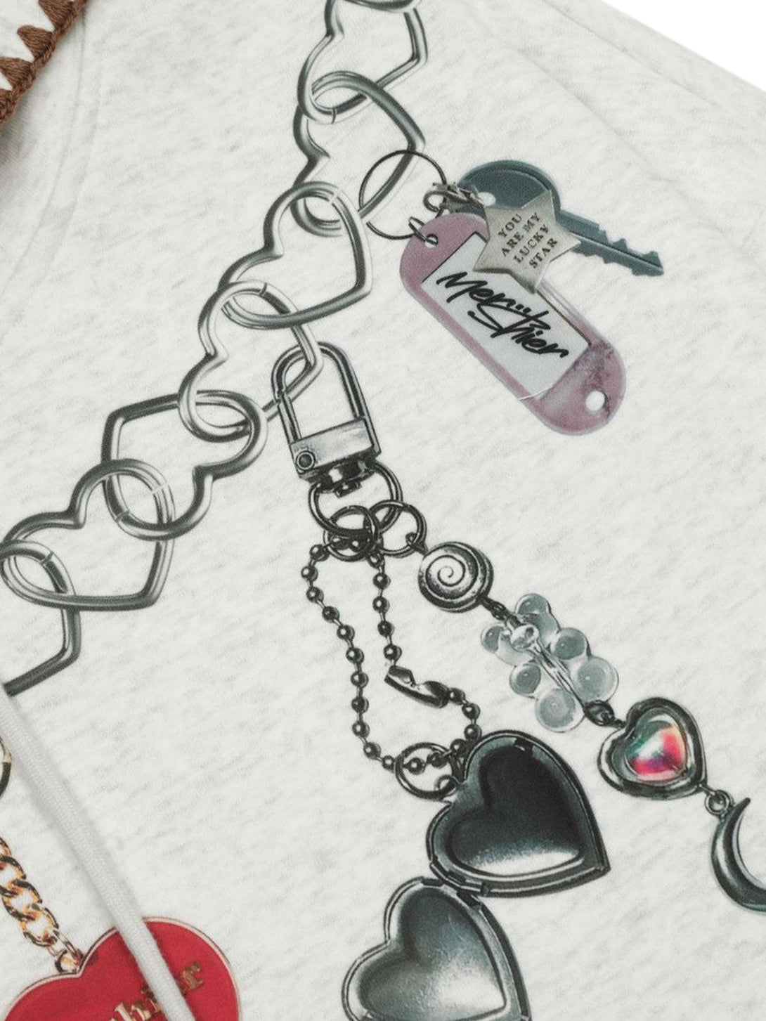 A detailed view of TALISHKO hoodie graphics, highlighting playful heart and chain designs.