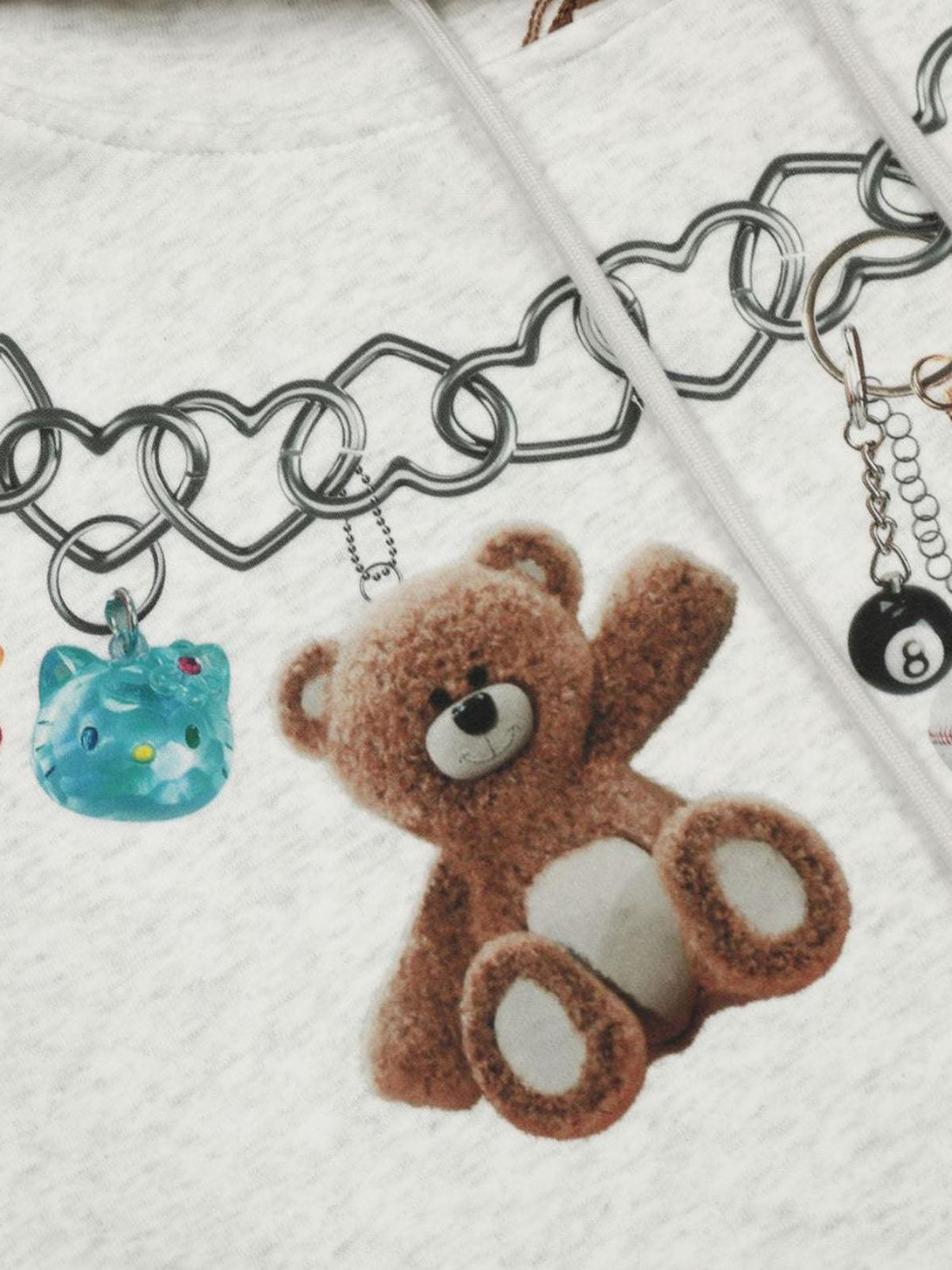 TALISHKO hoodie graphic detail highlighting a teddy bear with heart and chain accents.