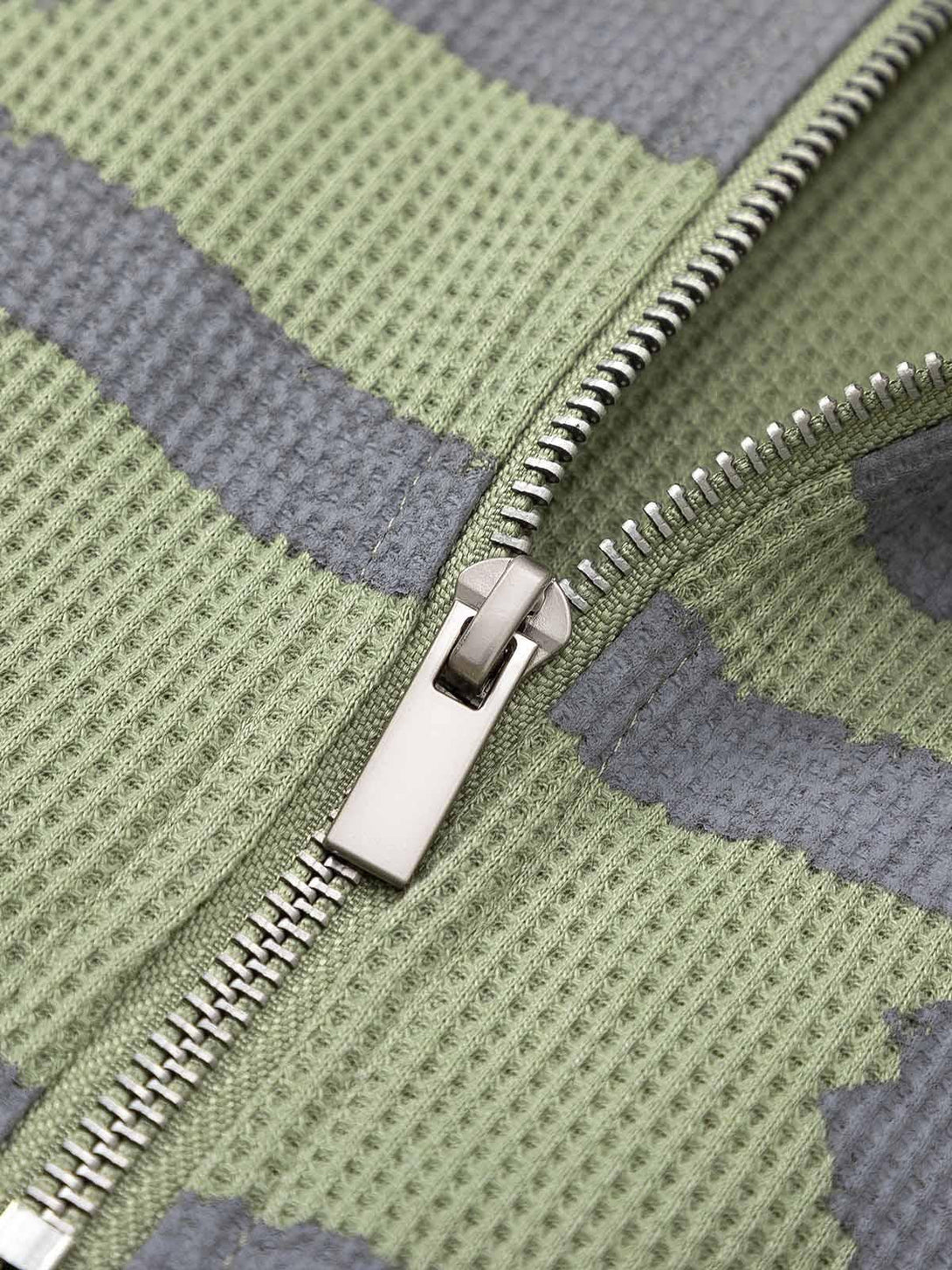 Detailed fabric and stitching of TALISHKO's half zip sweater, highlighting the unique pattern.