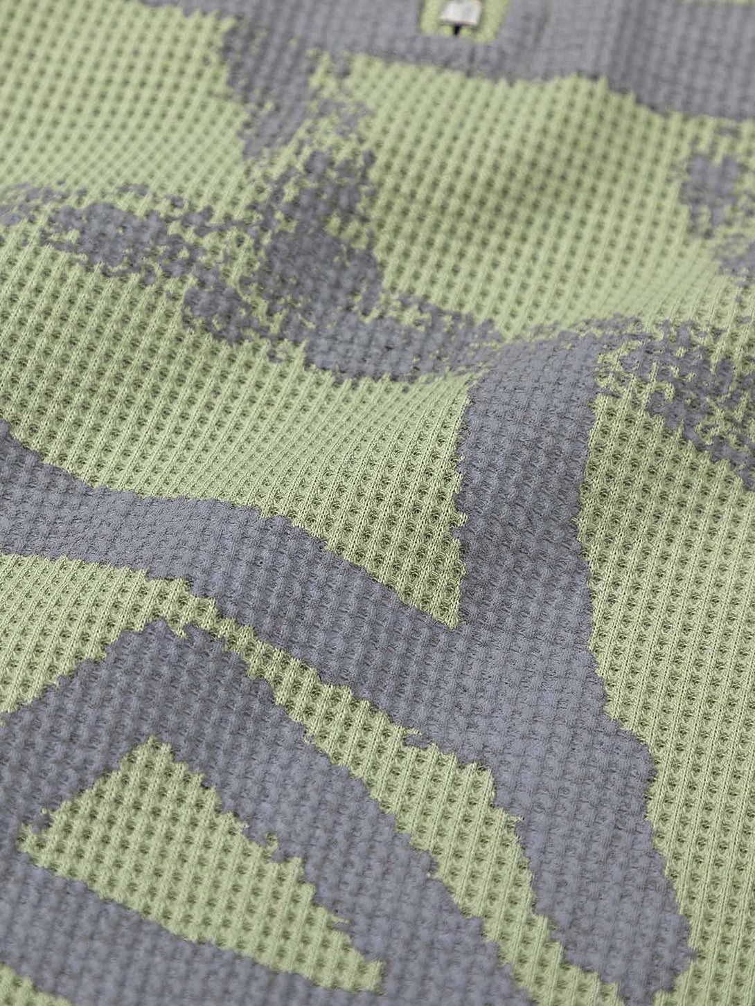 Detailed fabric and pattern of TALISHKO's sweater, showcasing the unique knit texture.