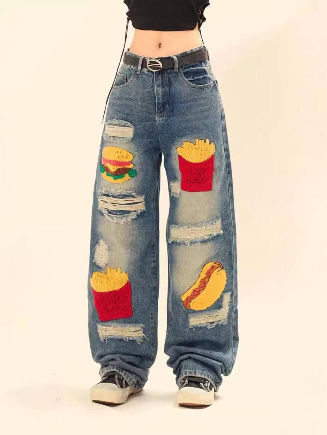 Model wearing TALISHKO ripped jeans with fun food patches, adding a quirky style to casual outfits.