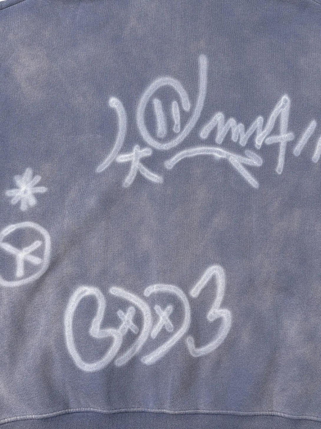 A detailed view of hand-drawn graffiti on TALISHKO's washed hoodie, highlighting artistic style.