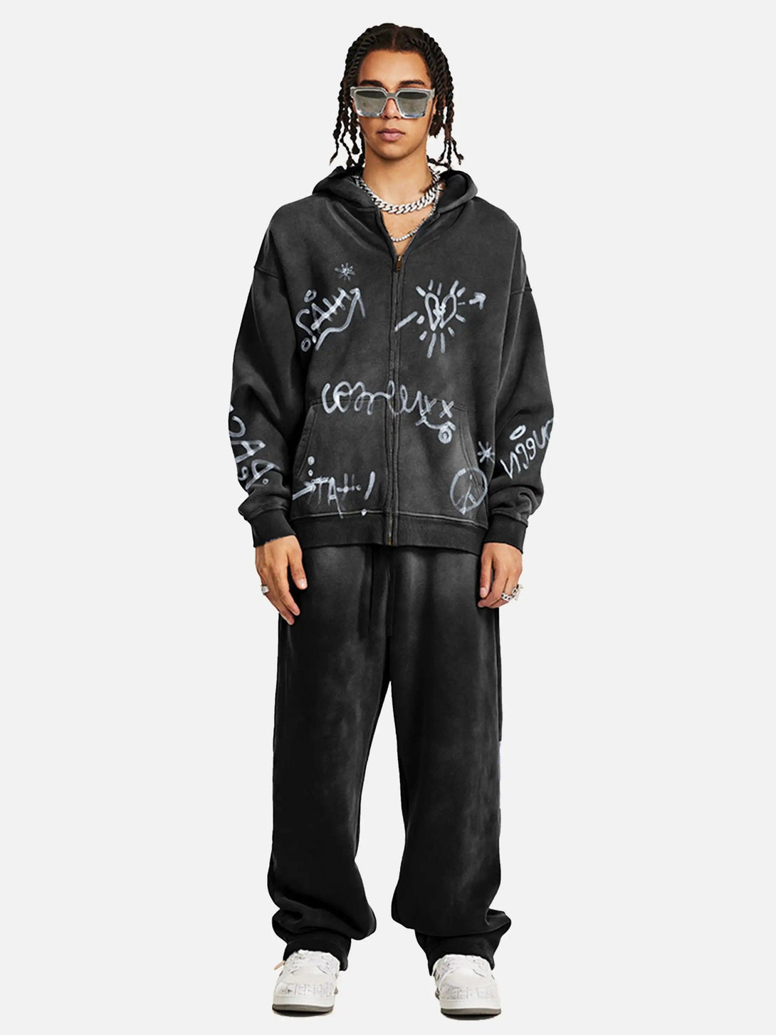 Model in TALISHKO's graffiti hoodie and pants, showcasing urban style with artistic flair.