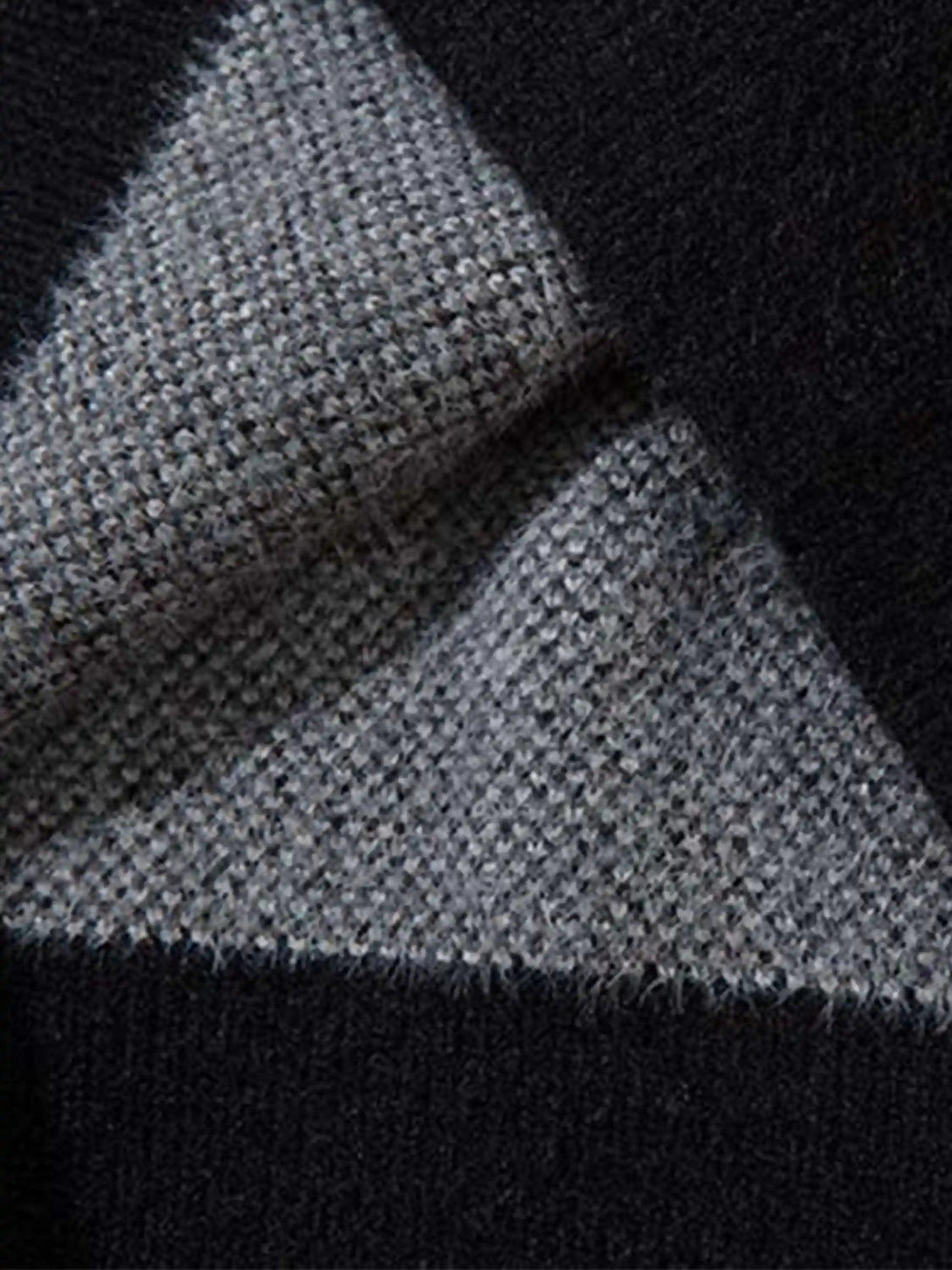 Zoomed-in texture of TALISHKO's mohair cardigan, showcasing intricate gray and black knit.