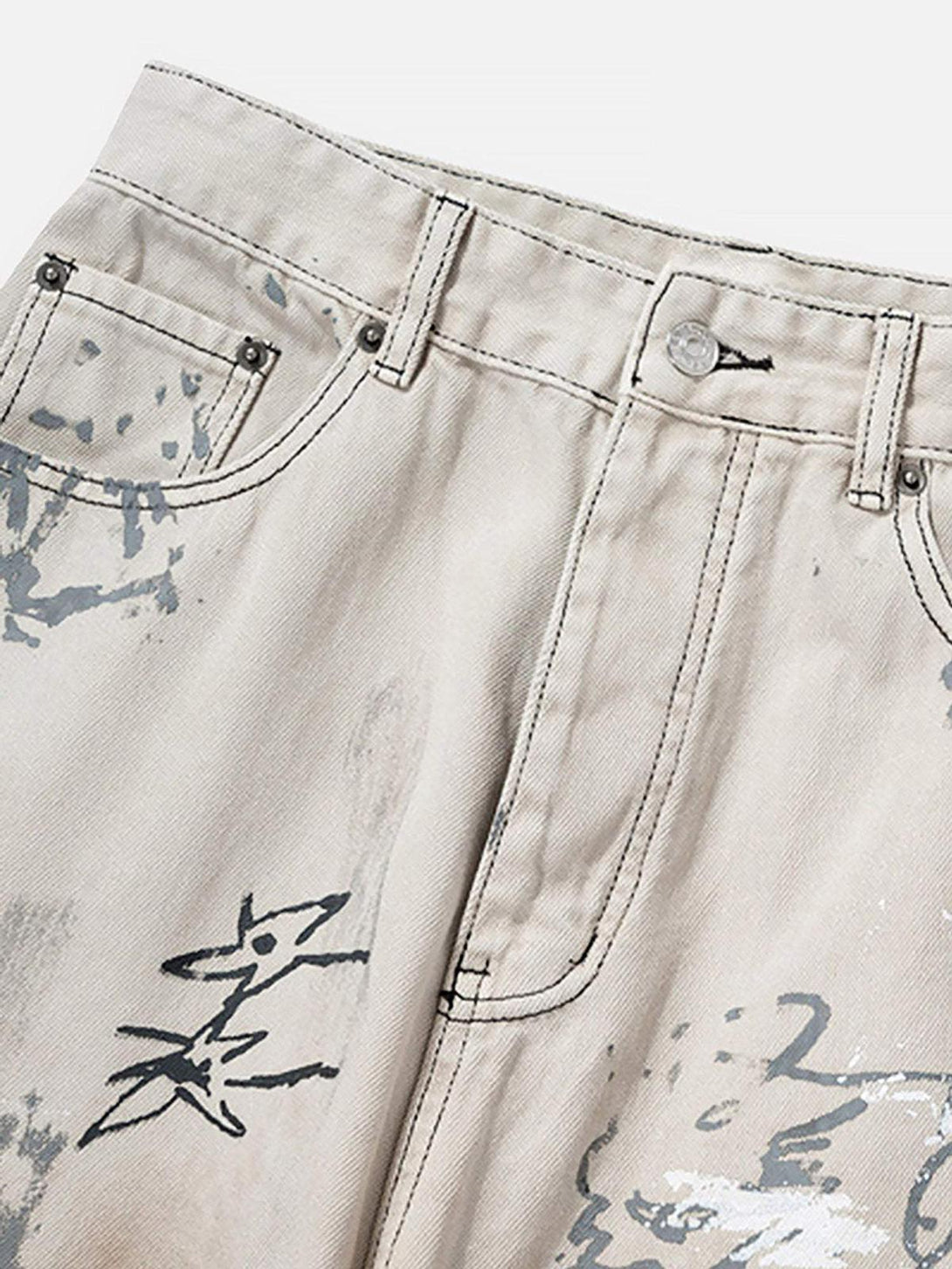 Intricate look at TALISHKO hand-painted graffiti detail on baggy jeans, enhancing streetwear flair.