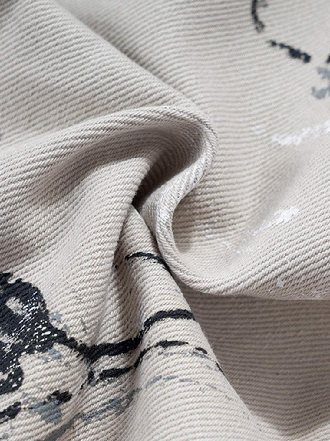 Texture and pattern showcased on TALISHKO hand-painted graffiti baggy jeans, highlighting artistic flair.