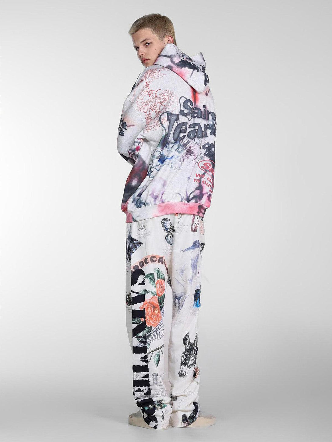 Model in TALISHKO graffiti hoodie and pants, showcasing artistic hand-painted designs.