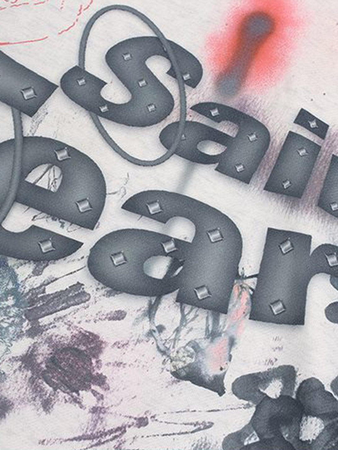 Intricate look at the hand-painted ink graffiti design on a TALISHKO hoodie, showcasing artistic flair.