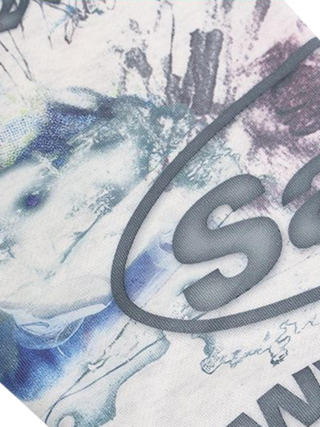 A close-up of the hand-painted ink graffiti design on a TALISHKO hoodie, highlighting unique textures.