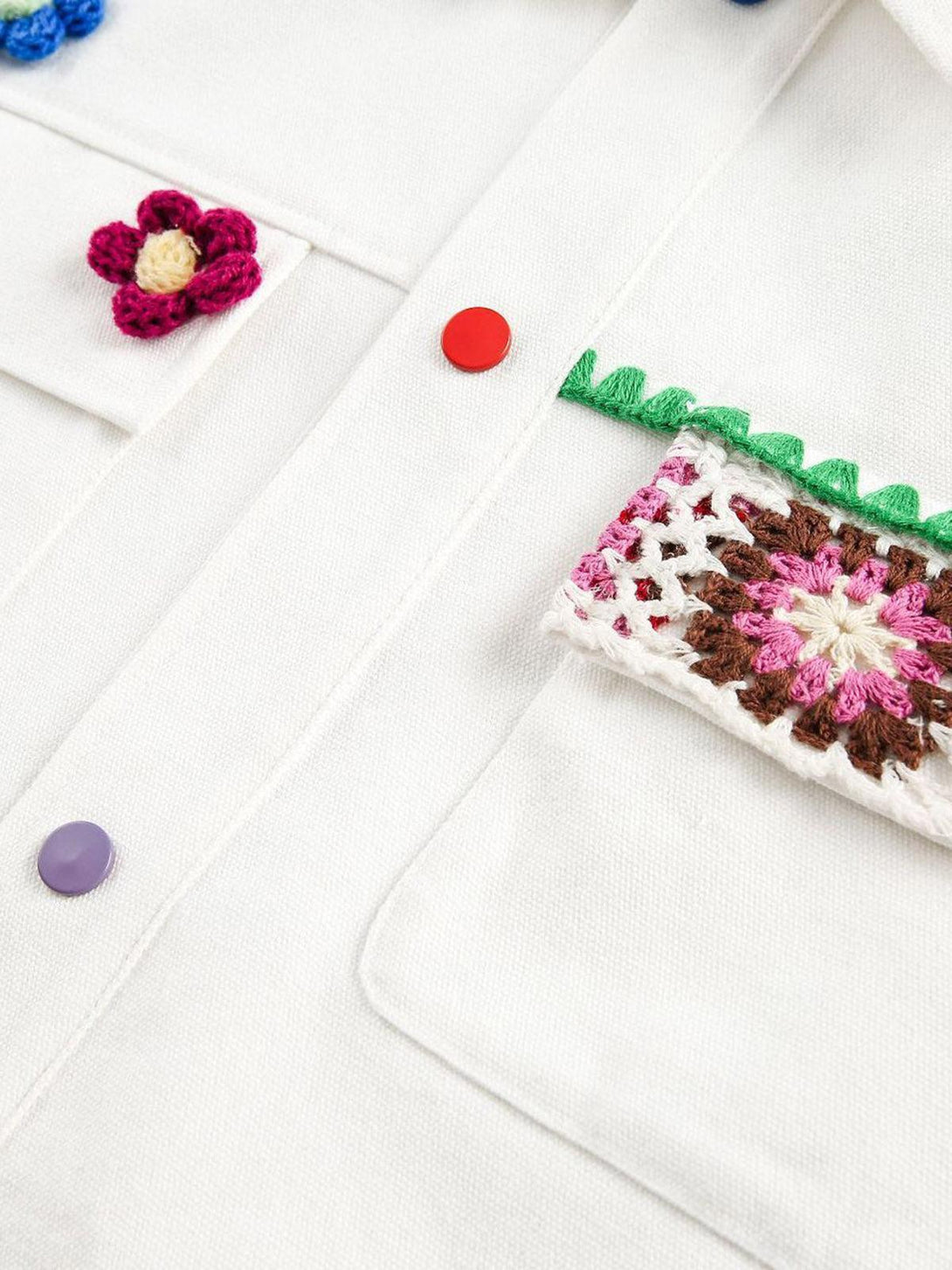 Intricate look at the TALISHKO denim jacket's colorful crochet floral details and vibrant buttons.