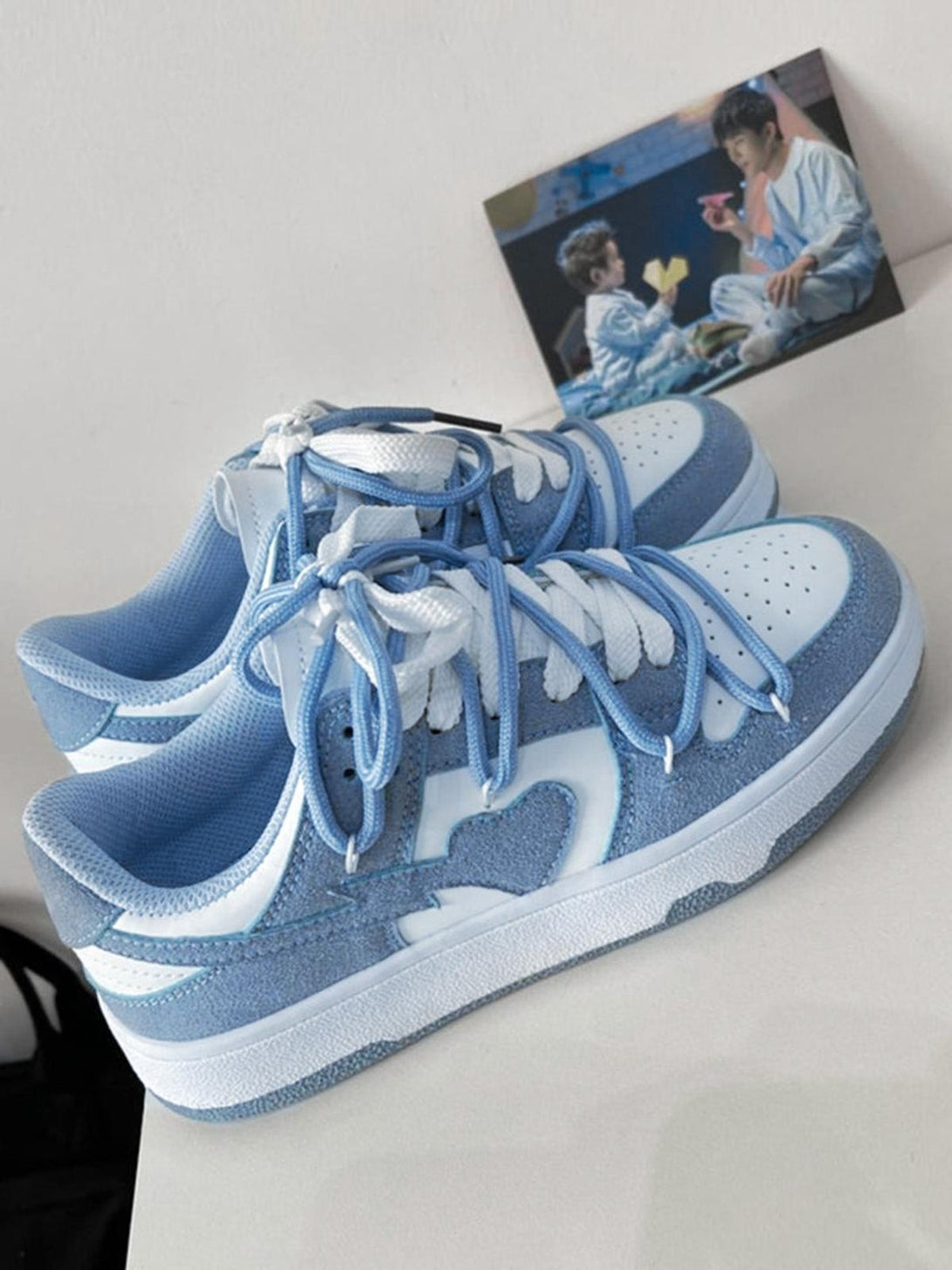 TALISHKO haze blue board shoes with unique heart detailing and breathable mesh fabric.