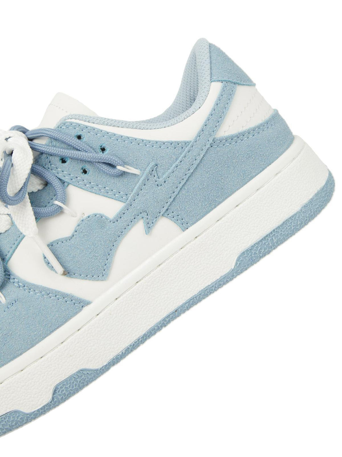 A detailed look at TALISHKO haze blue board shoes, showcasing suede texture and stitching.