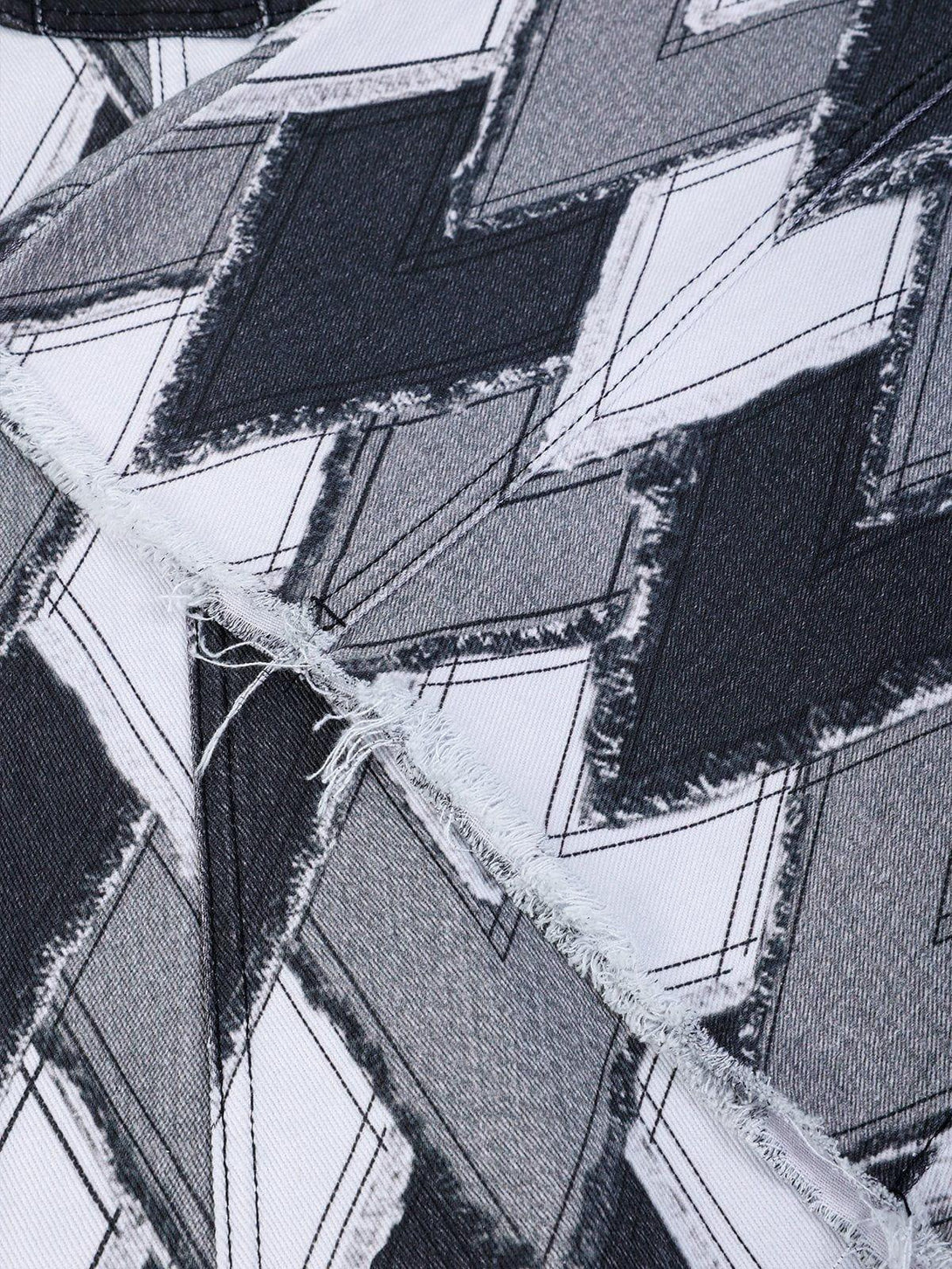 Detailed fabric and stitching of TALISHKO heart patchwork jorts, highlighting the zigzag pattern.