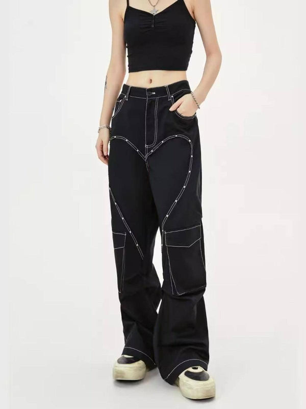 Model wearing TALISHKO heart rivet multi-pocket jeans with contrast stitching and a black crop top.