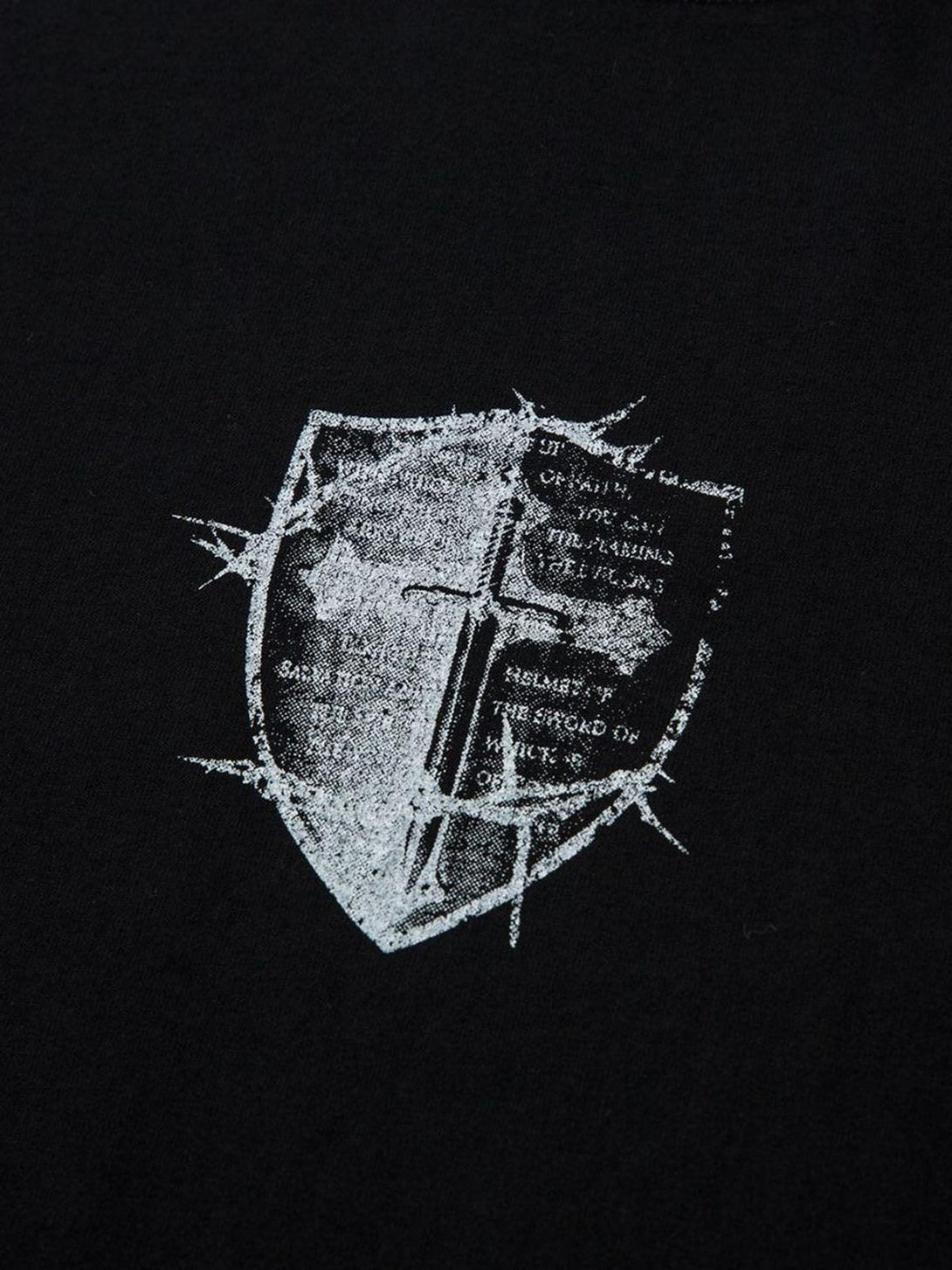 Close-up of the cross shield print on TALISHKO's heavy cotton T-shirt, highlighting its unique texture.