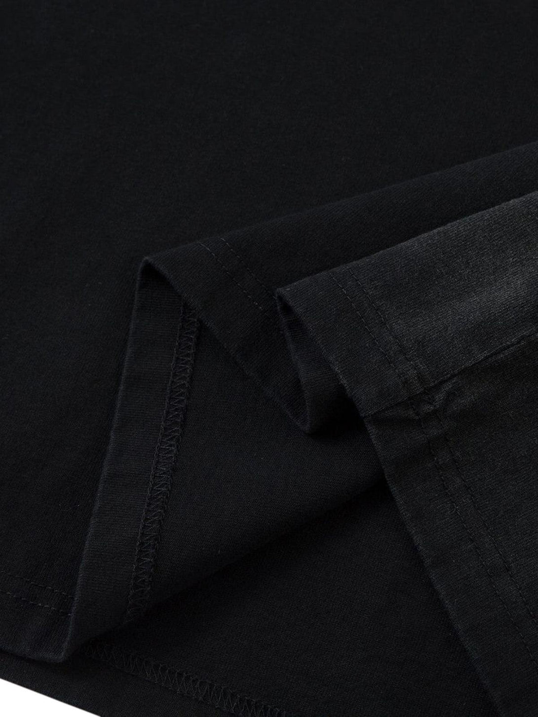 Detailed stitching of TALISHKO's black T-shirt, showcasing its premium heavy cotton fabric.