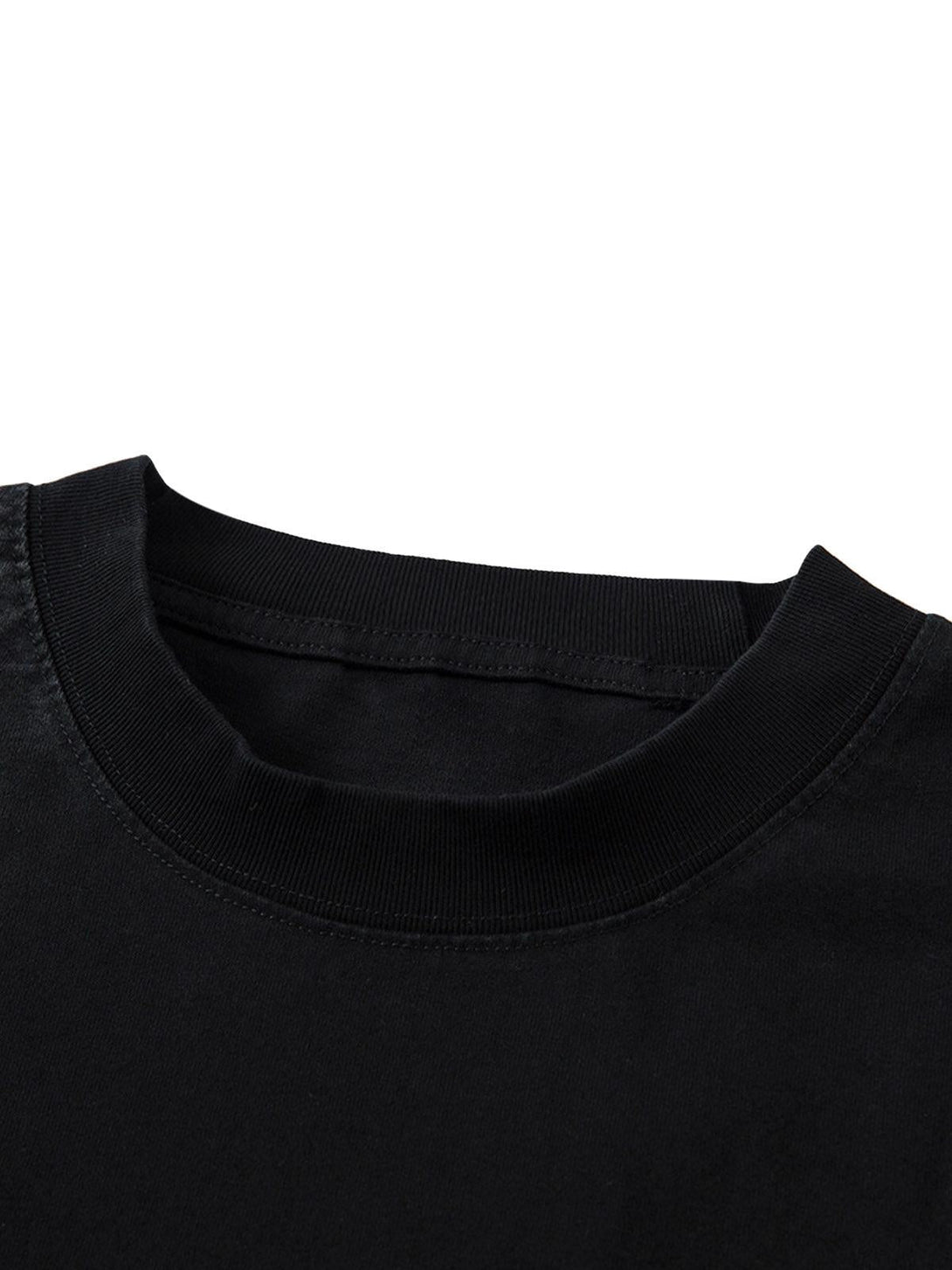 Detailed fabric and stitching of TALISHKO's black T-shirt, highlighting its quality material.