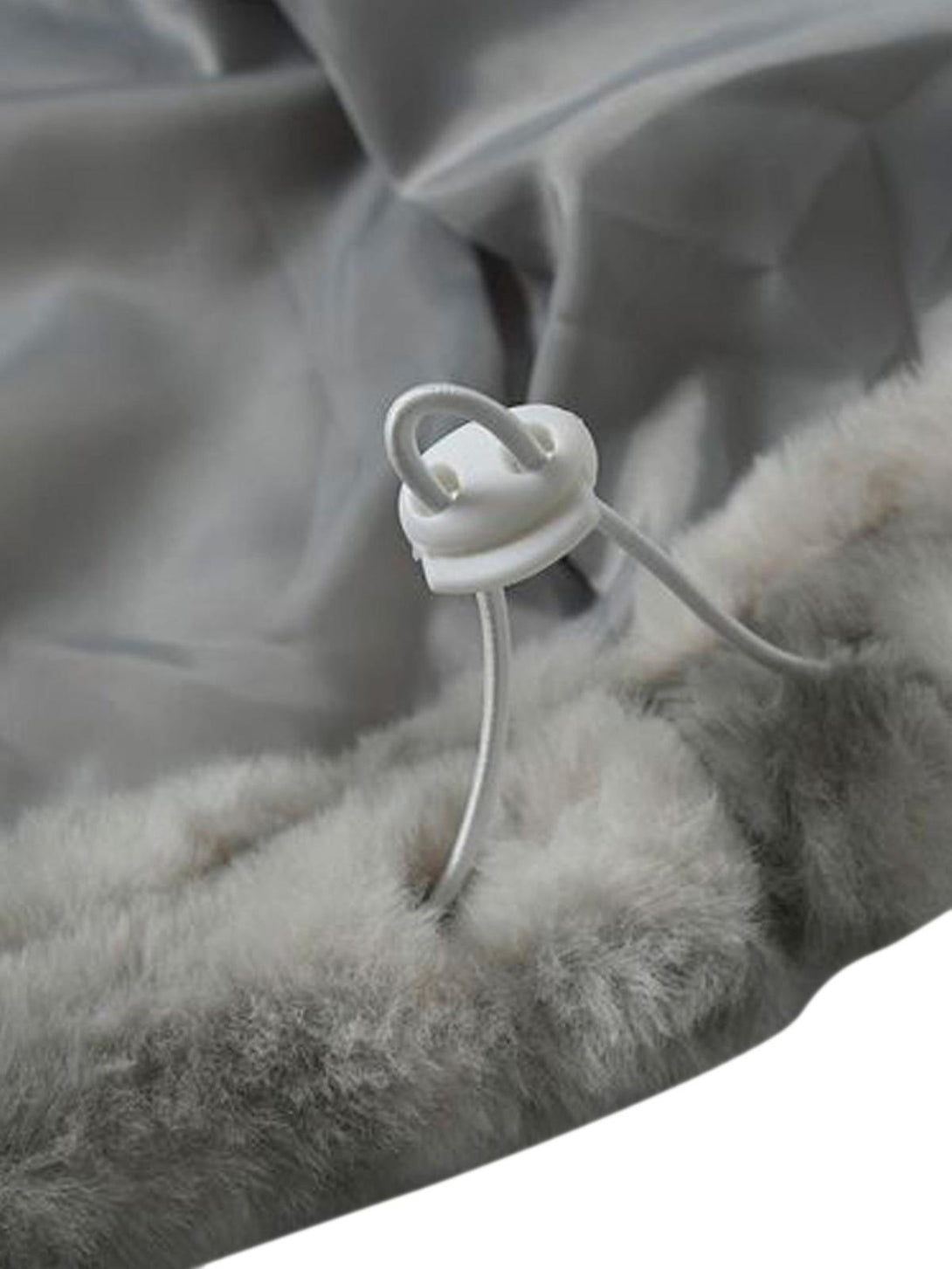 A detailed view of TALISHKO's faux lambswool jacket, highlighting the secure drawstring closure.