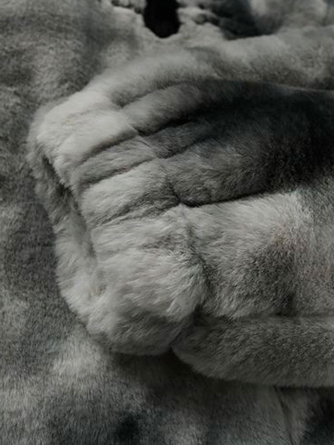 Plush texture of TALISHKO's tie-dye urban jacket in faux lambswool, offering cozy warmth.