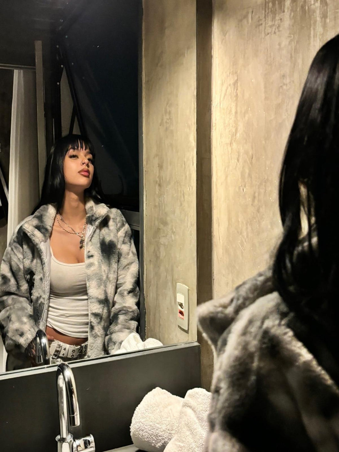 TALISHKO's tie-dye urban jacket in faux lambswool, styled confidently in a mirror reflection.