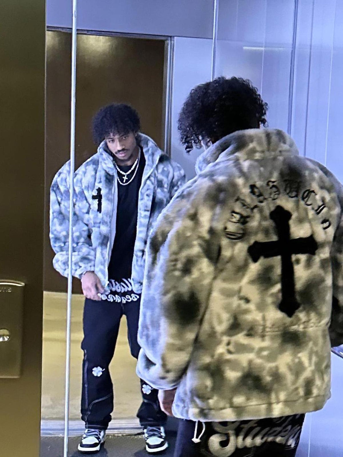 TALISHKO's urban tie-dye jacket in faux lambswool, styled confidently in front of a mirror.