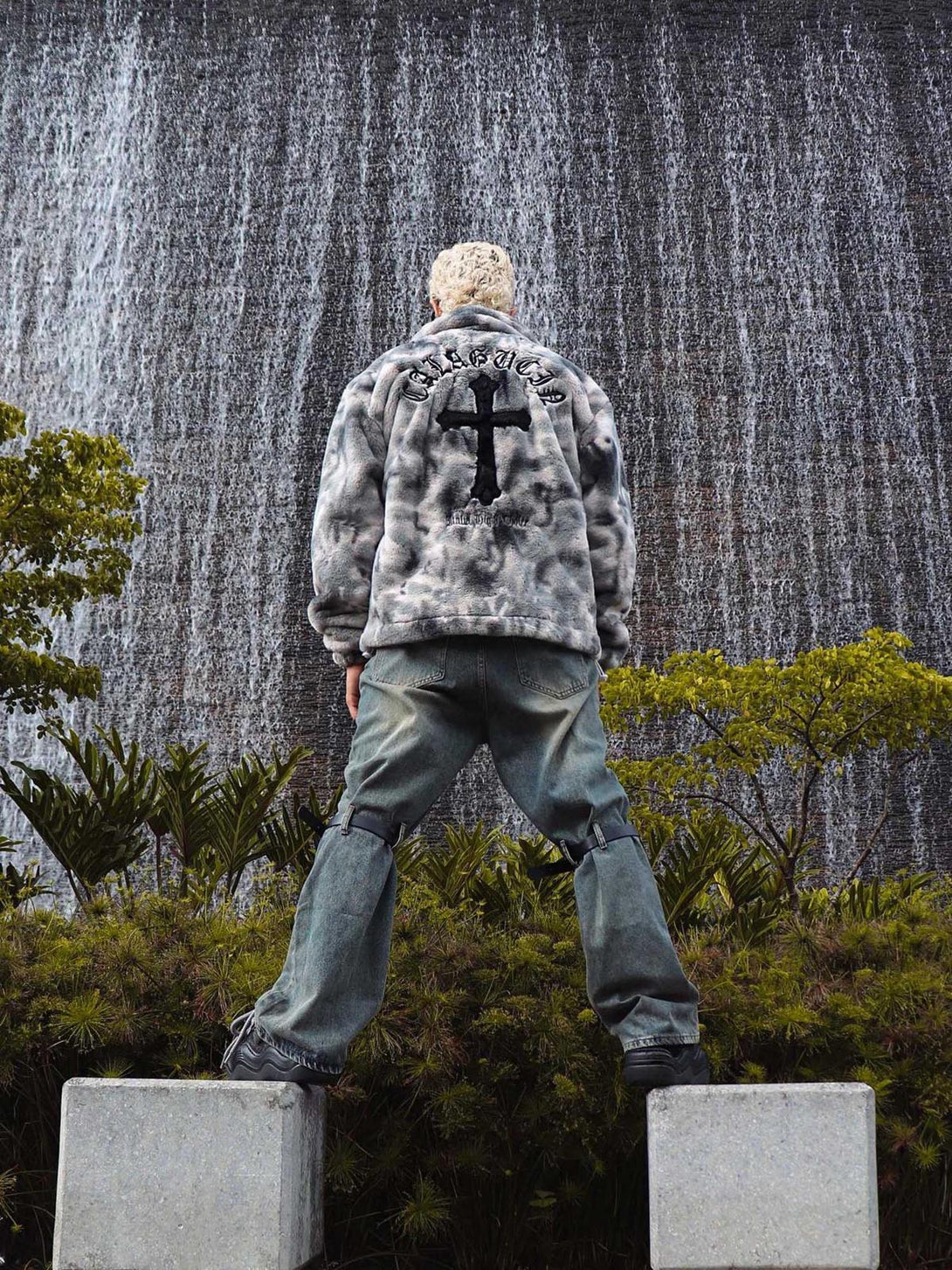 Urban style meets nature with TALISHKO's tie-dye faux lambswool jacket, captured in a dynamic back view.